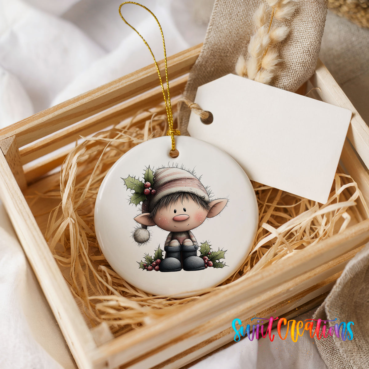 A wooden crate containing a white ceramic ornament with a cartoon elf design, placed on a bed of straw.