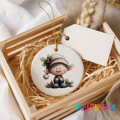 A wooden crate containing a white ceramic ornament with a cartoon elf design, placed on a bed of straw.