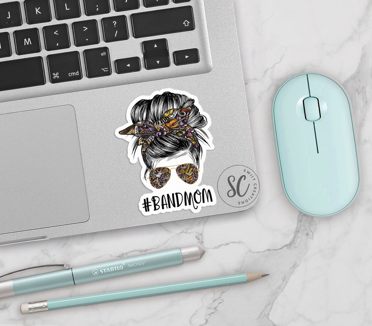 a laptop with a sticker of a woman's head