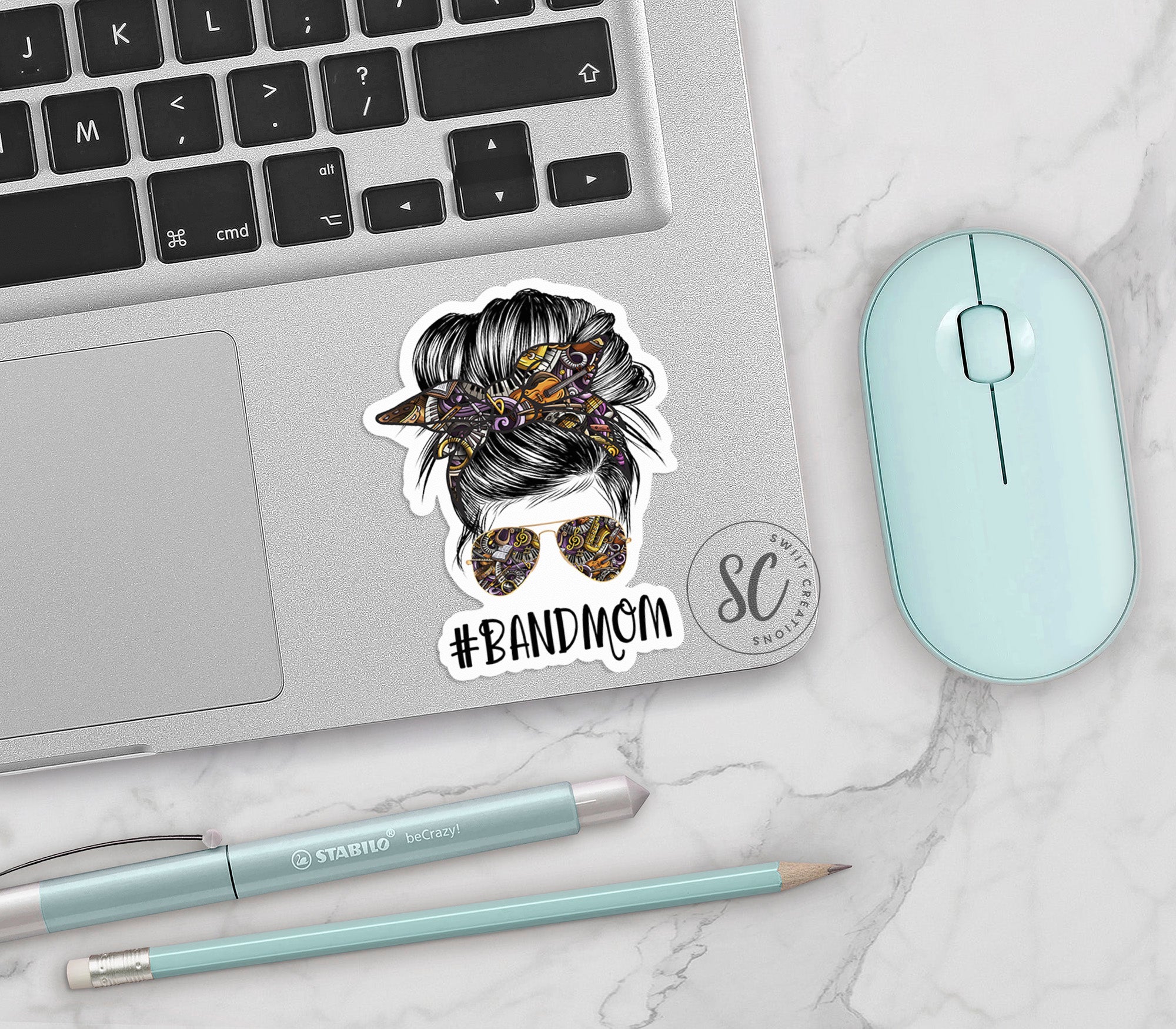 a laptop with a sticker of a woman's head