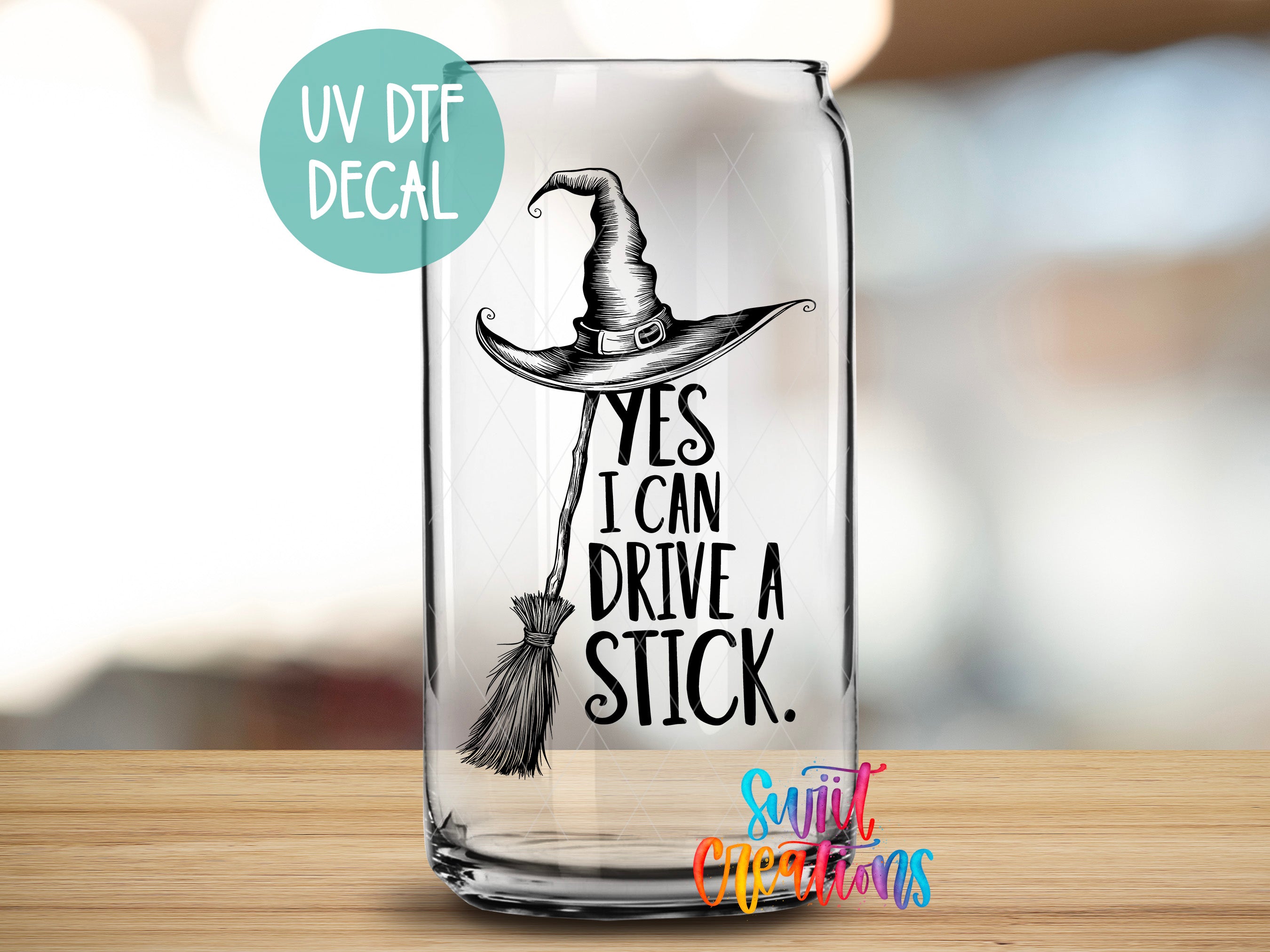 A glass can with a black and white illustration of a witch's hat and the text "YES I CAN DRIVE A STICK" printed on it.