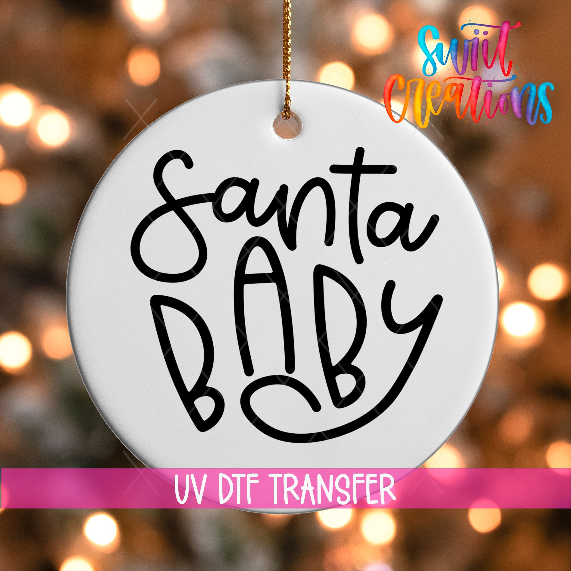 A white ornament with the text "Santa Baby" written on it, hanging against a background of colorful lights.