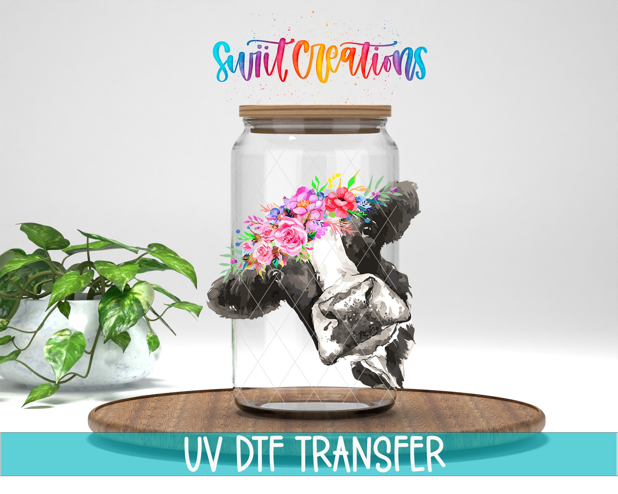 a glass jar with a floral design inside, placed on a wooden surface. The jar is surrounded by a potted plant, and there is text at the bottom of the image that says "UV DFT Transfer".