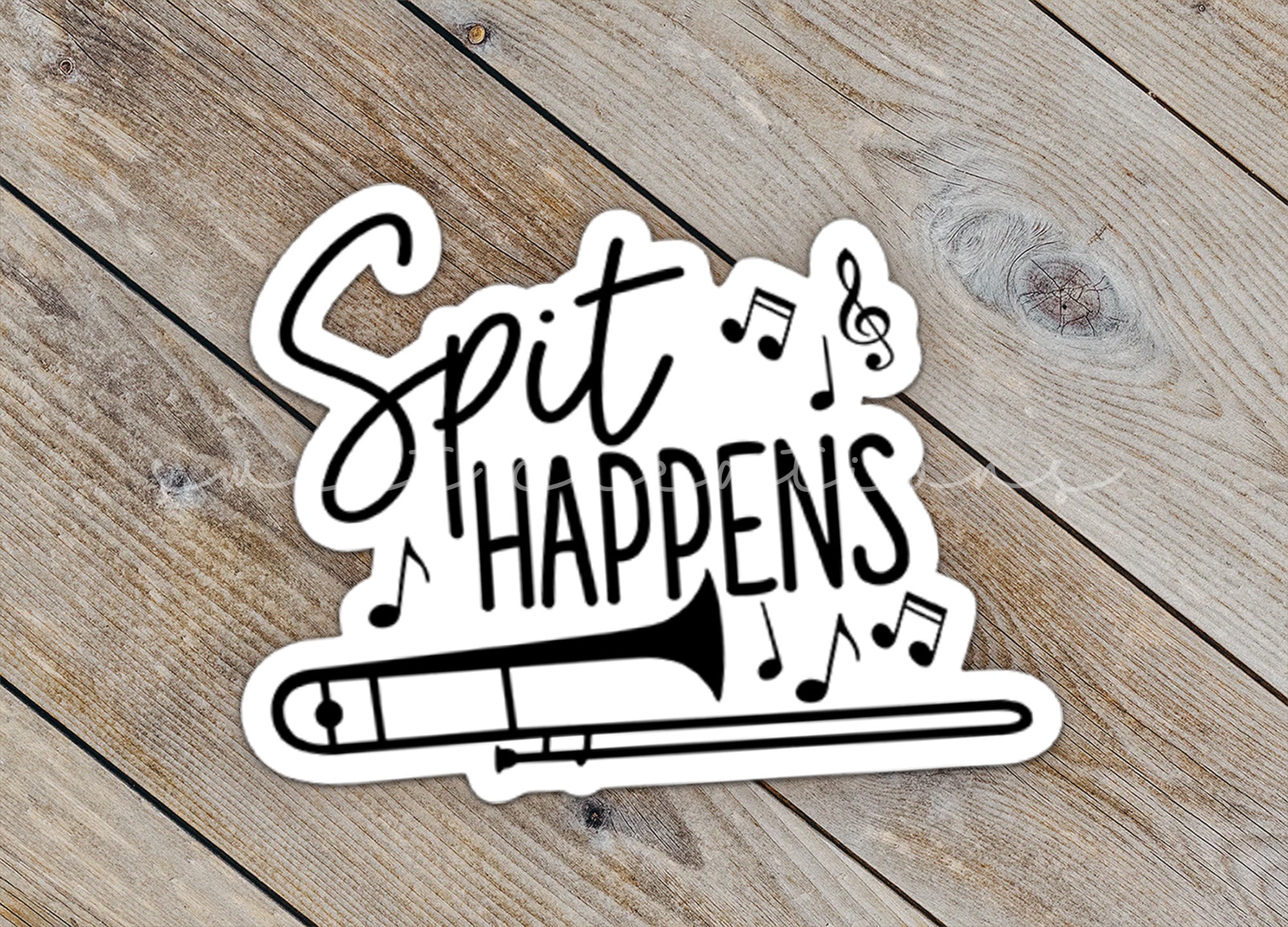 a sticker that says sit happens on a wooden surface