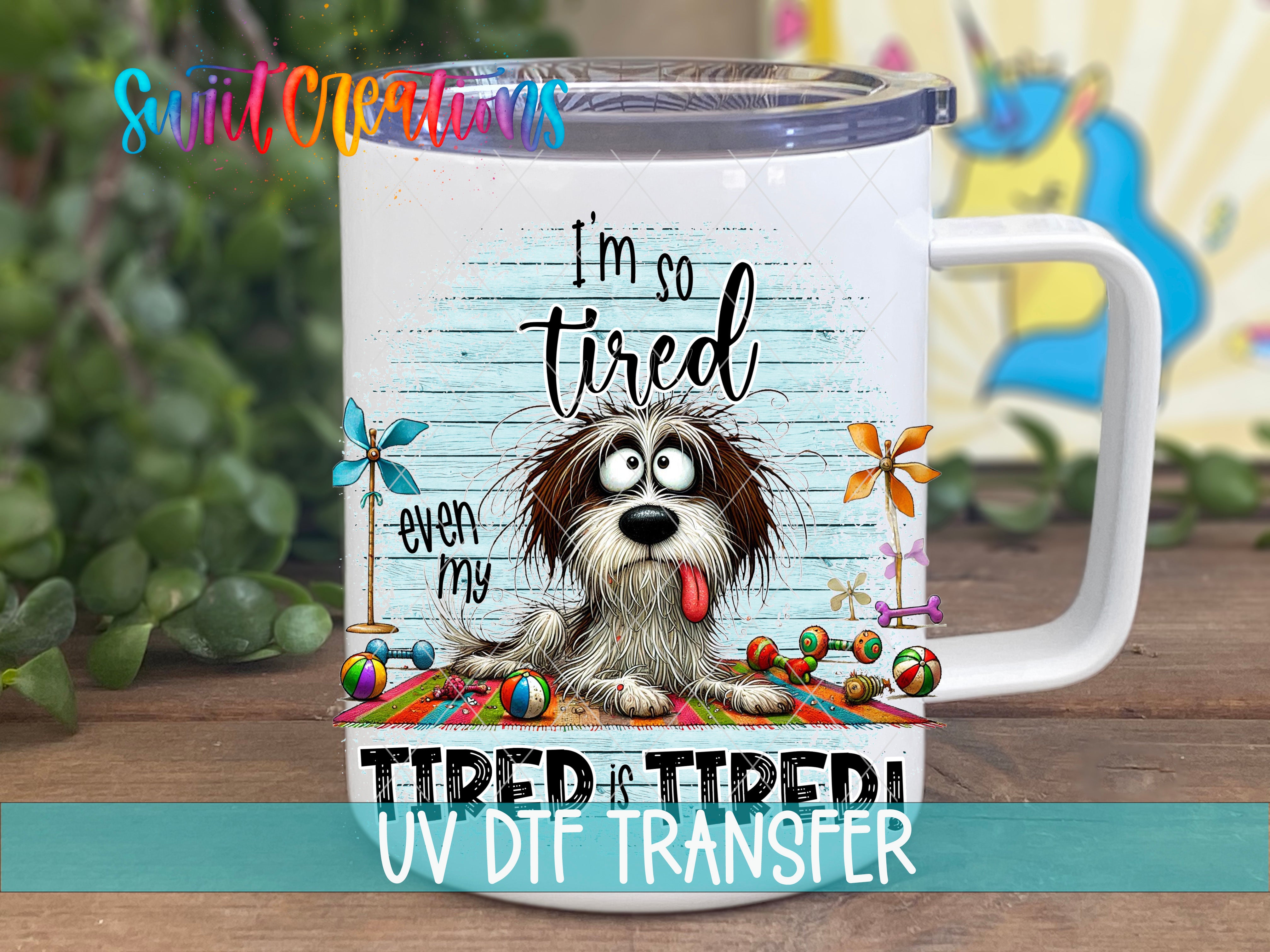A mug with a cartoon image of a dog and the text "I'm so tired even my tongue is tired" printed on it.