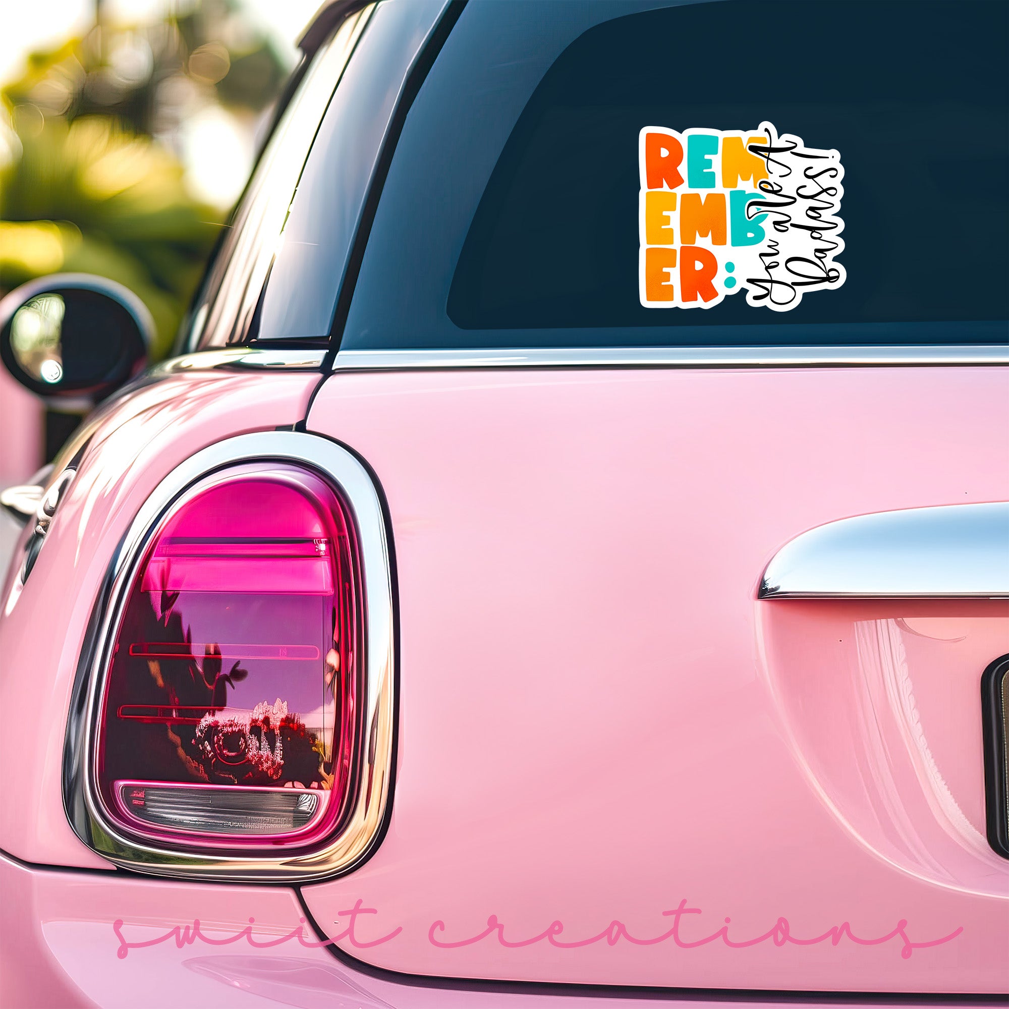 a pink car with a sticker on it
