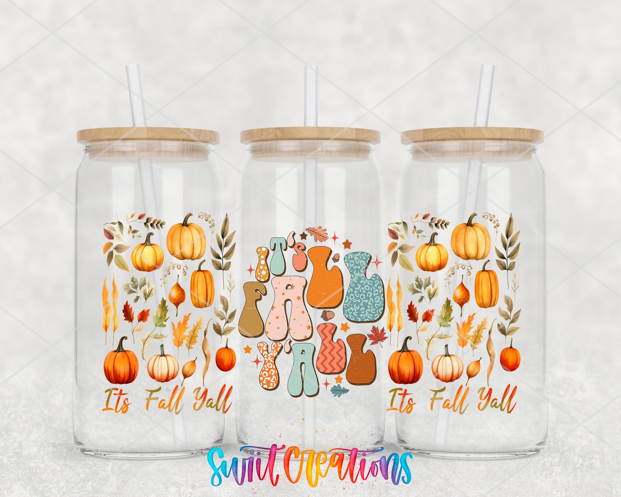 Three glass tumblers with straws, each featuring a colorful autumn-themed design with pumpkins, leaves, and other fall-related elements.