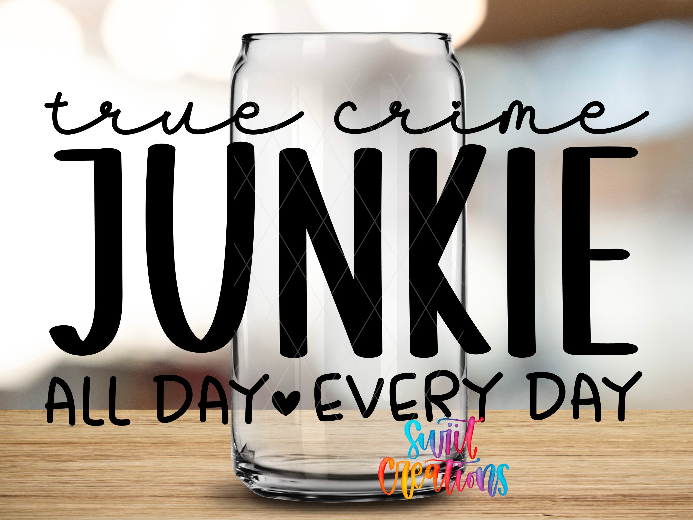 a large text overlay that reads "True crime JUNKIE all day every day" in a bold, black font. The text is placed over a blurred background, which appears to be a glass can.