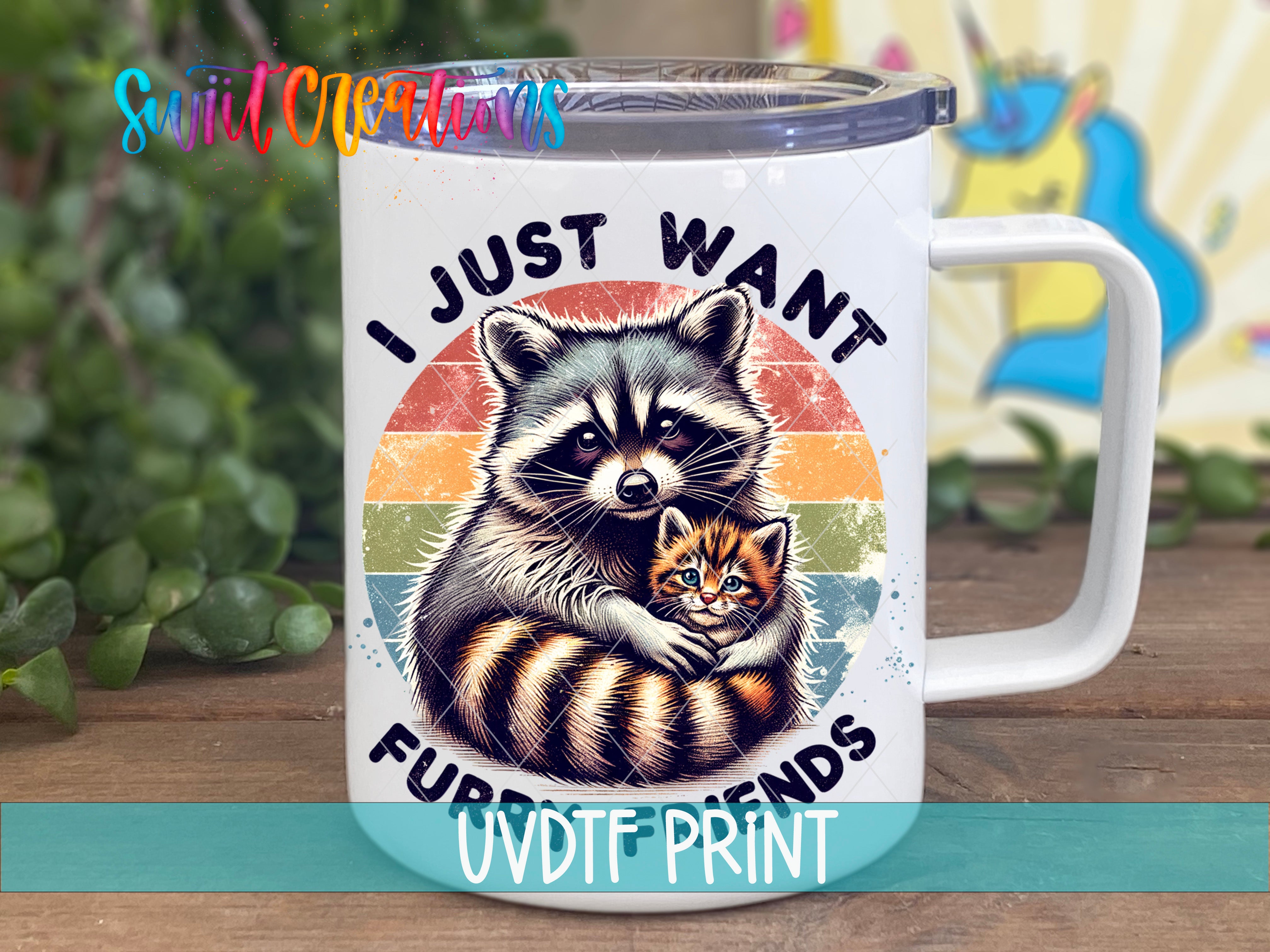 A white mug with a colorful graphic design featuring a raccoon and a kitten, along with the text "I JUST WANT FURRIED FRIENDS" and "UVDF PRINT".