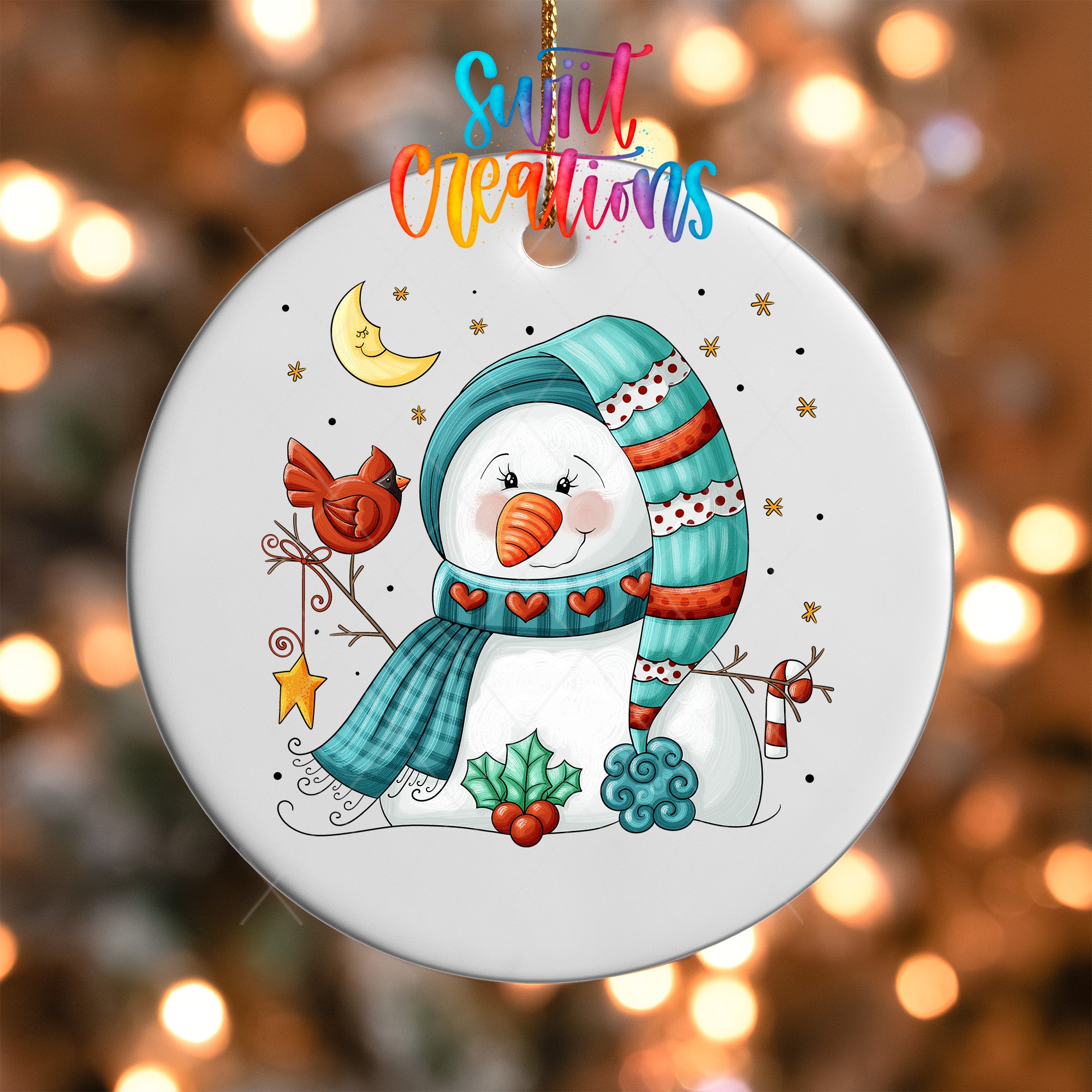 A snowman ornament with a scarf, hat, and other winter-themed decorations, including a bird and a crescent moon, is hanging against a background of twinkling lights.