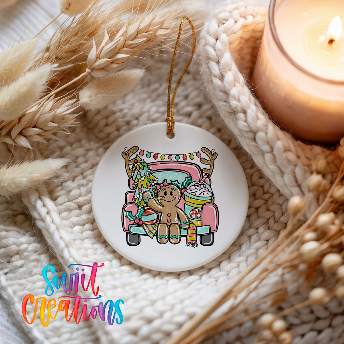 A white ceramic ornament featuring a gingerbread man sitting in a pink truck, surrounded by holiday decorations such as dried flowers and a lit candle.