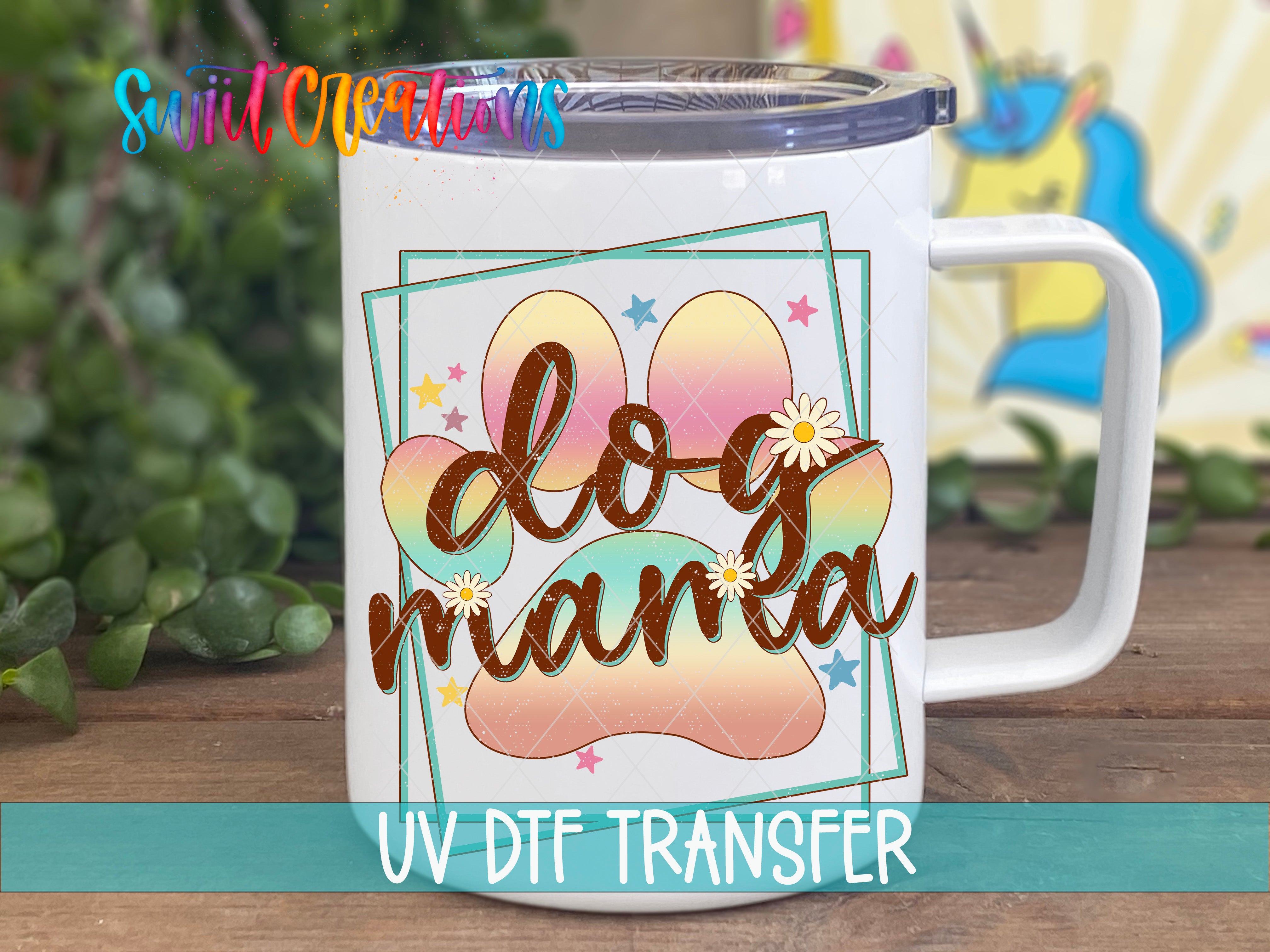 A white ceramic mug with a colorful graphic design featuring a dog paw and the text "Do g mama" printed on it.