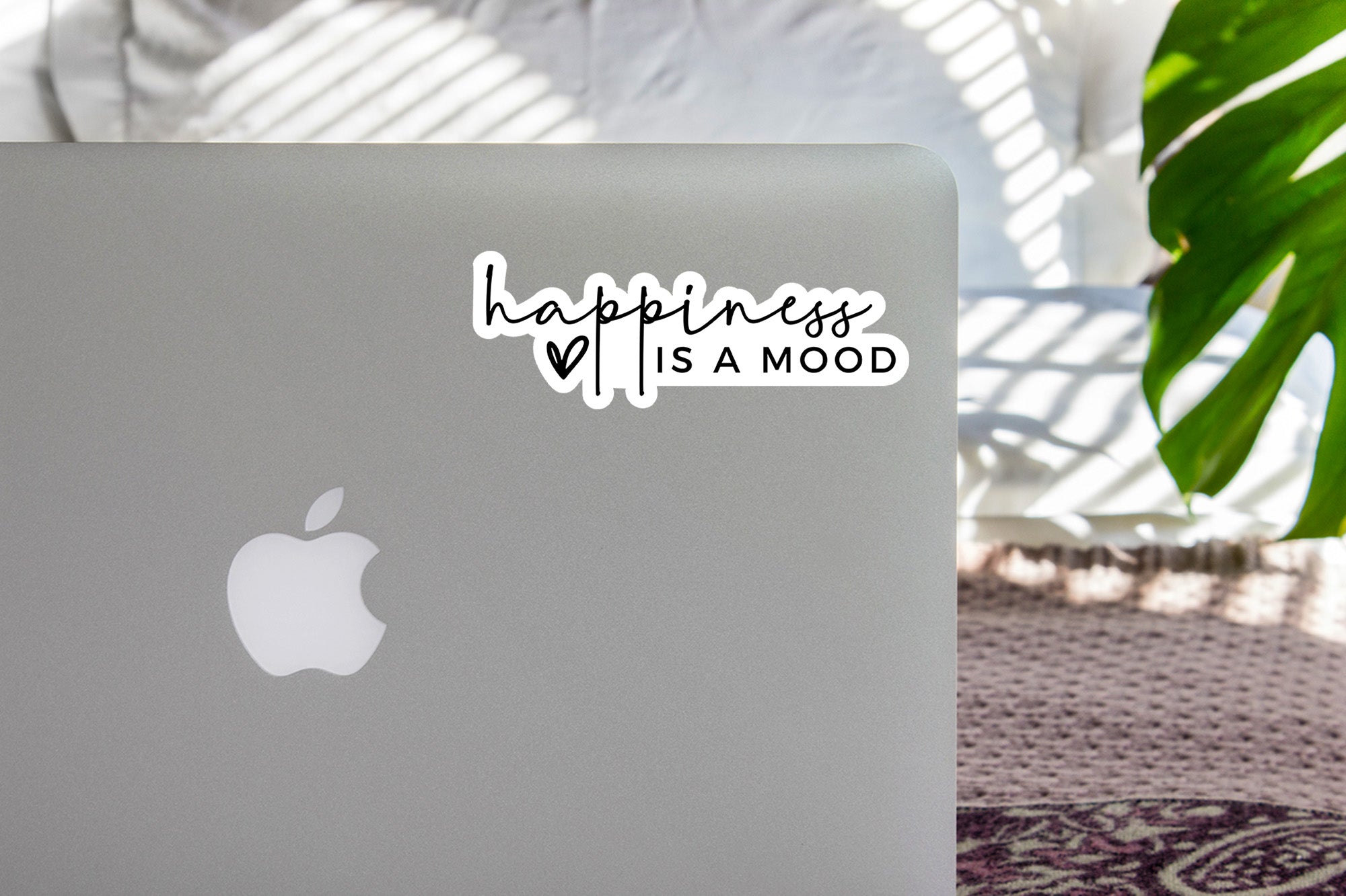 a laptop with a sticker that says happiness is a mood