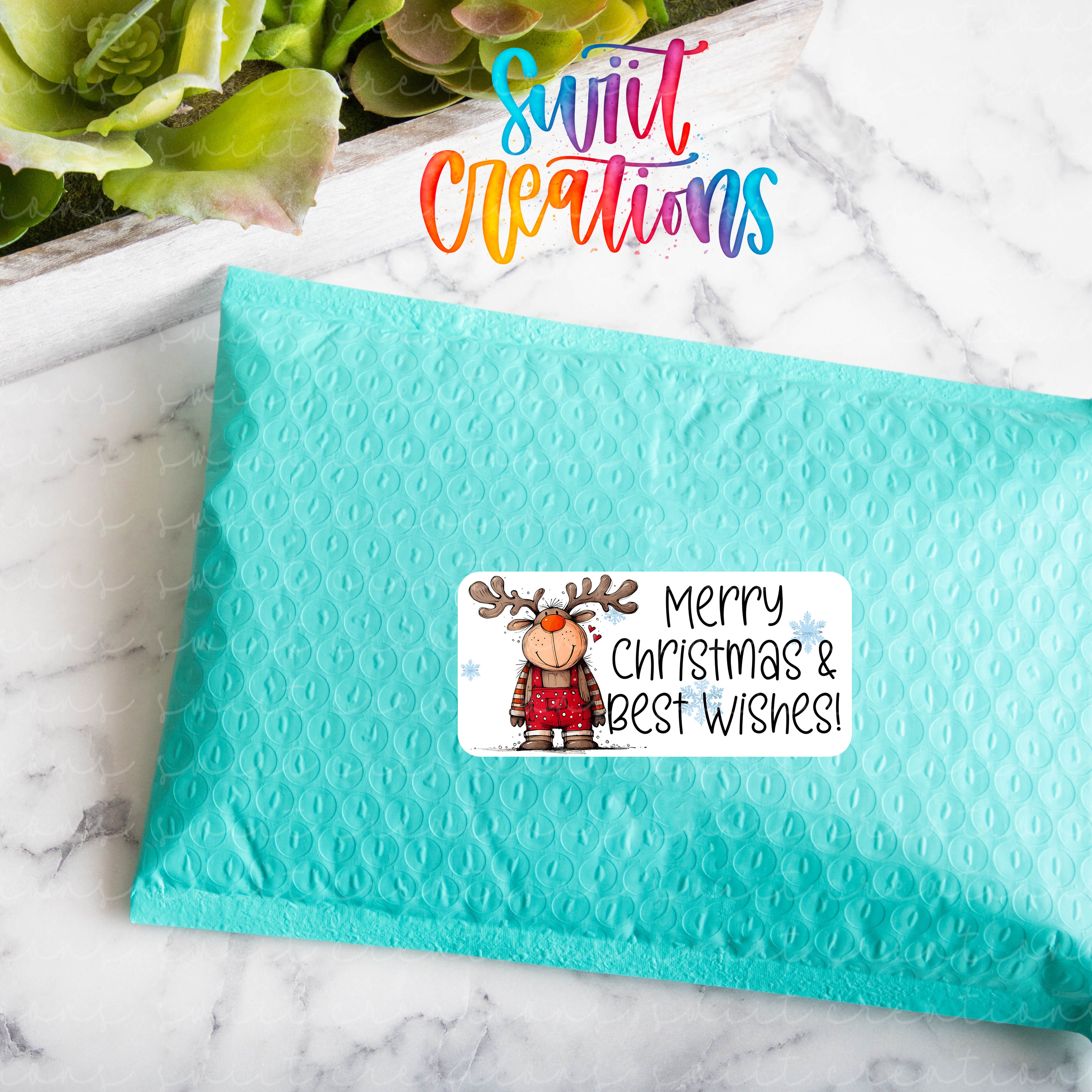 a blue envelope with a christmas sticker on it