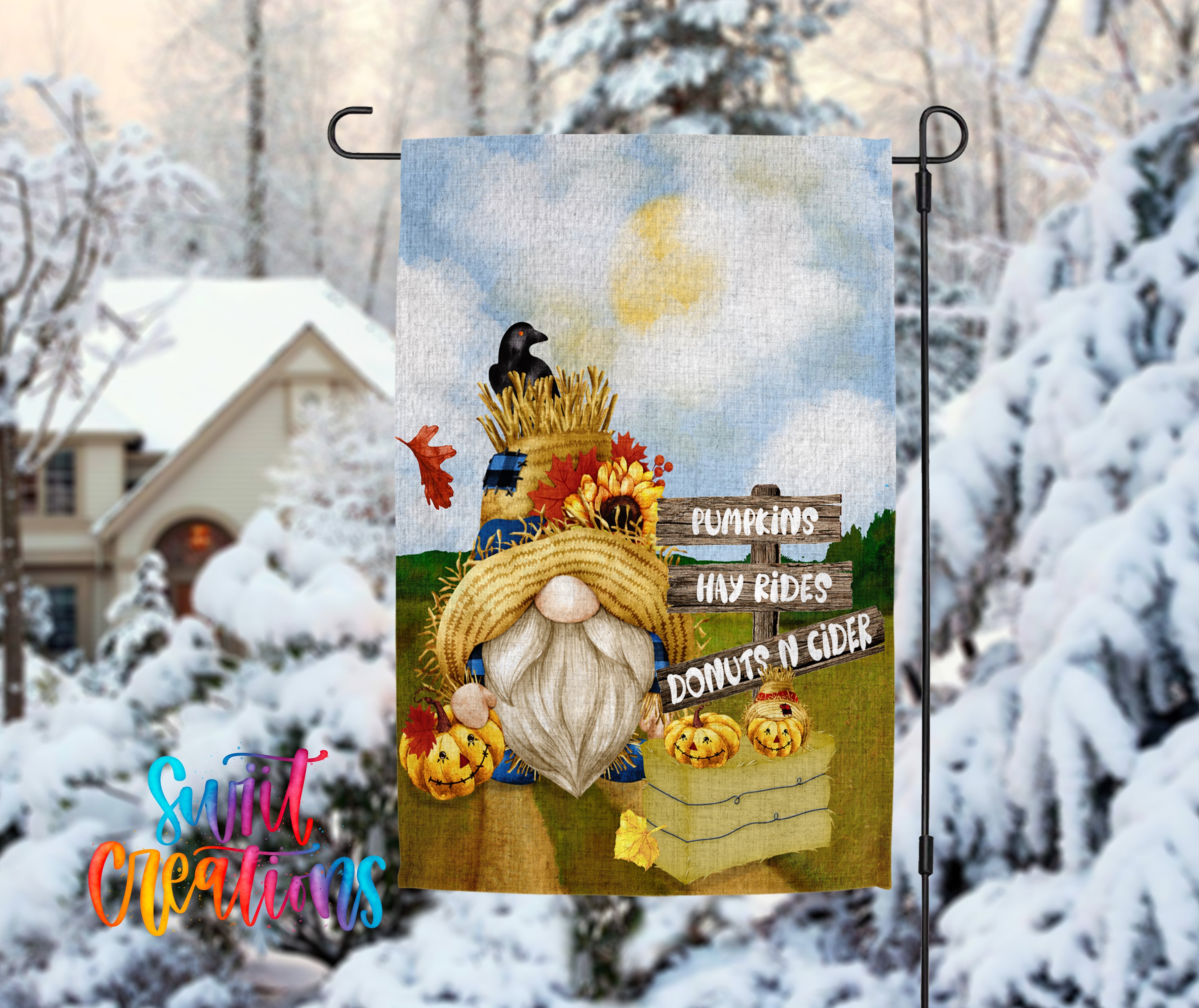 A colorful garden gnome with a straw hat and a basket of pumpkins and apples, set against a snowy landscape with a house in the background.
