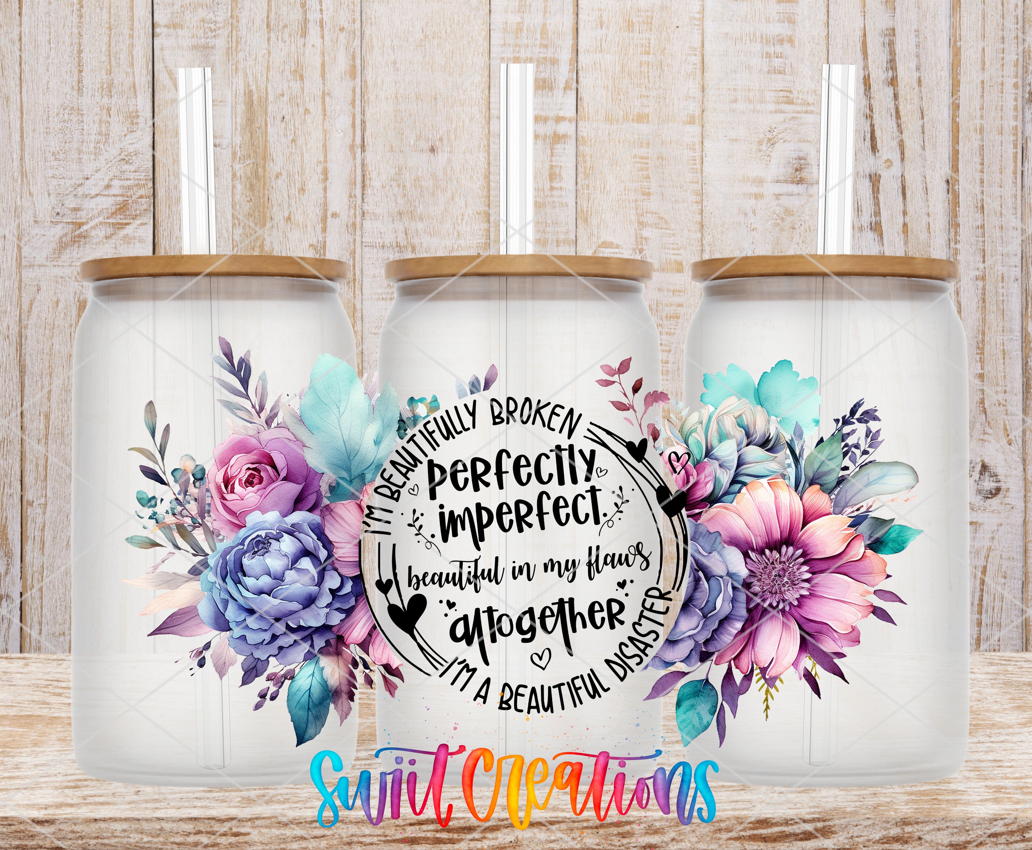 three glass tumblers with floral designs, including purple, pink, and blue flowers, and straws. The text on the tumblers reads "I'm beautifully imperfect. I'm beautiful in my flowers. I'm a beautiful disaster. I'm a beautiful disaster together." The text is surrounded by a circular design with flowers and leaves.