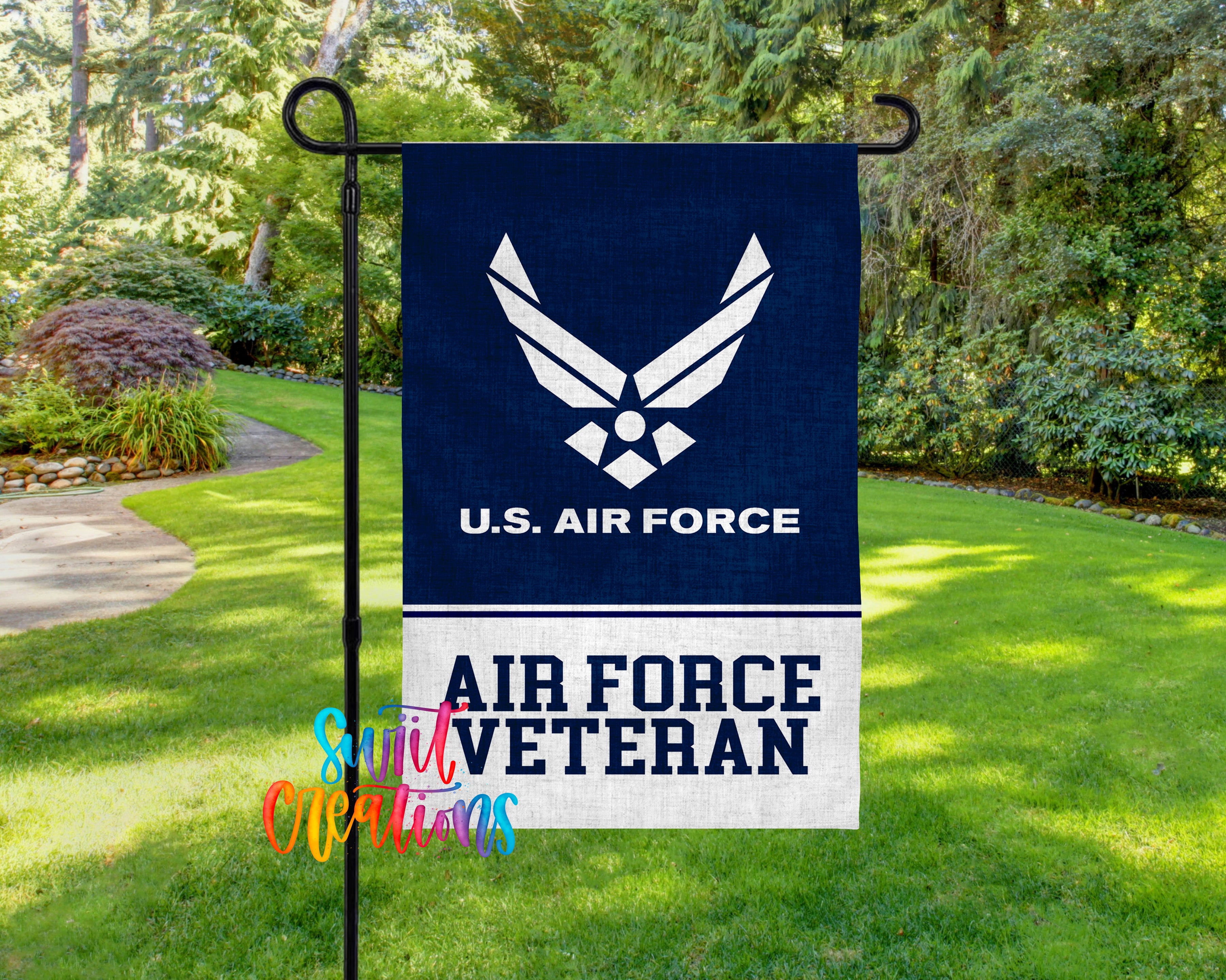 A flag with the U.S. Air Force logo and the text "AIR FORCE VETERAN" is displayed in a grassy area surrounded by trees.