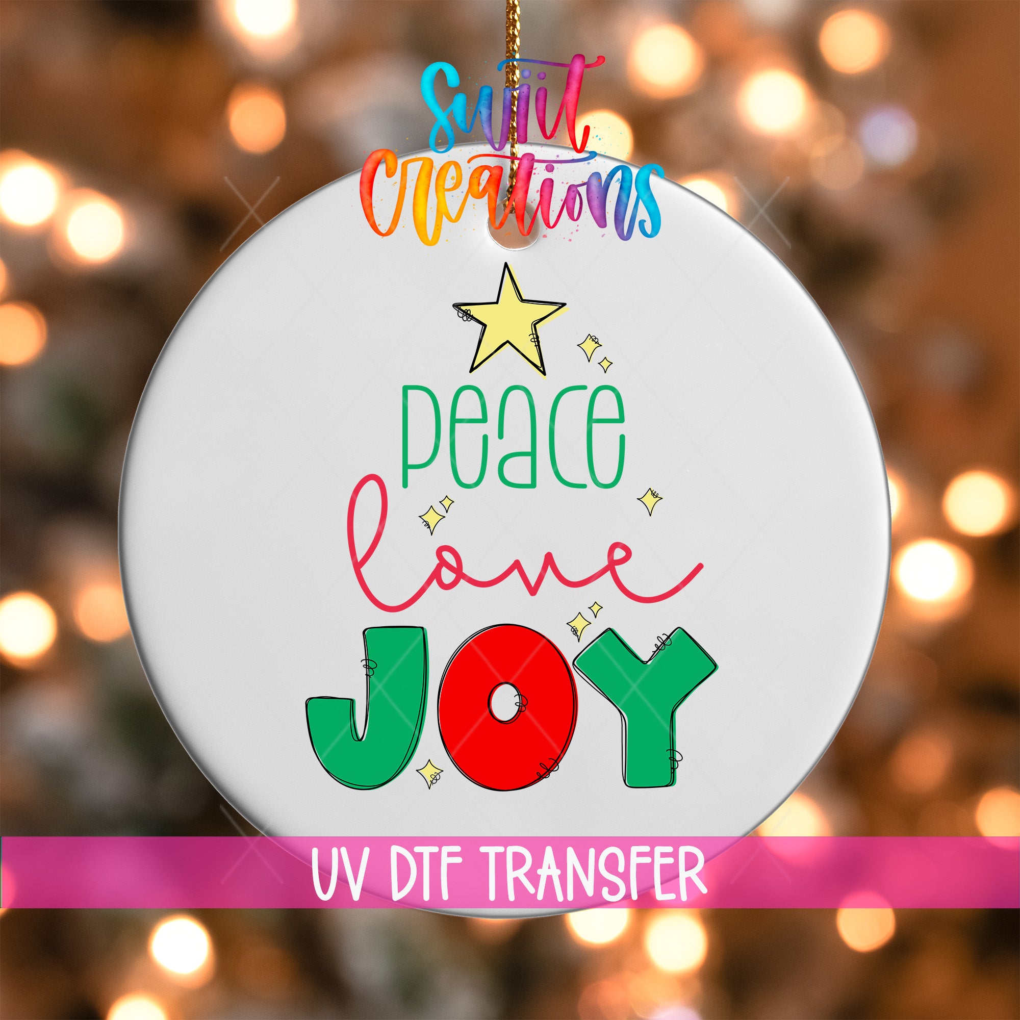 A white ornament with colorful text and a star, hanging against a blurred background with Christmas lights.