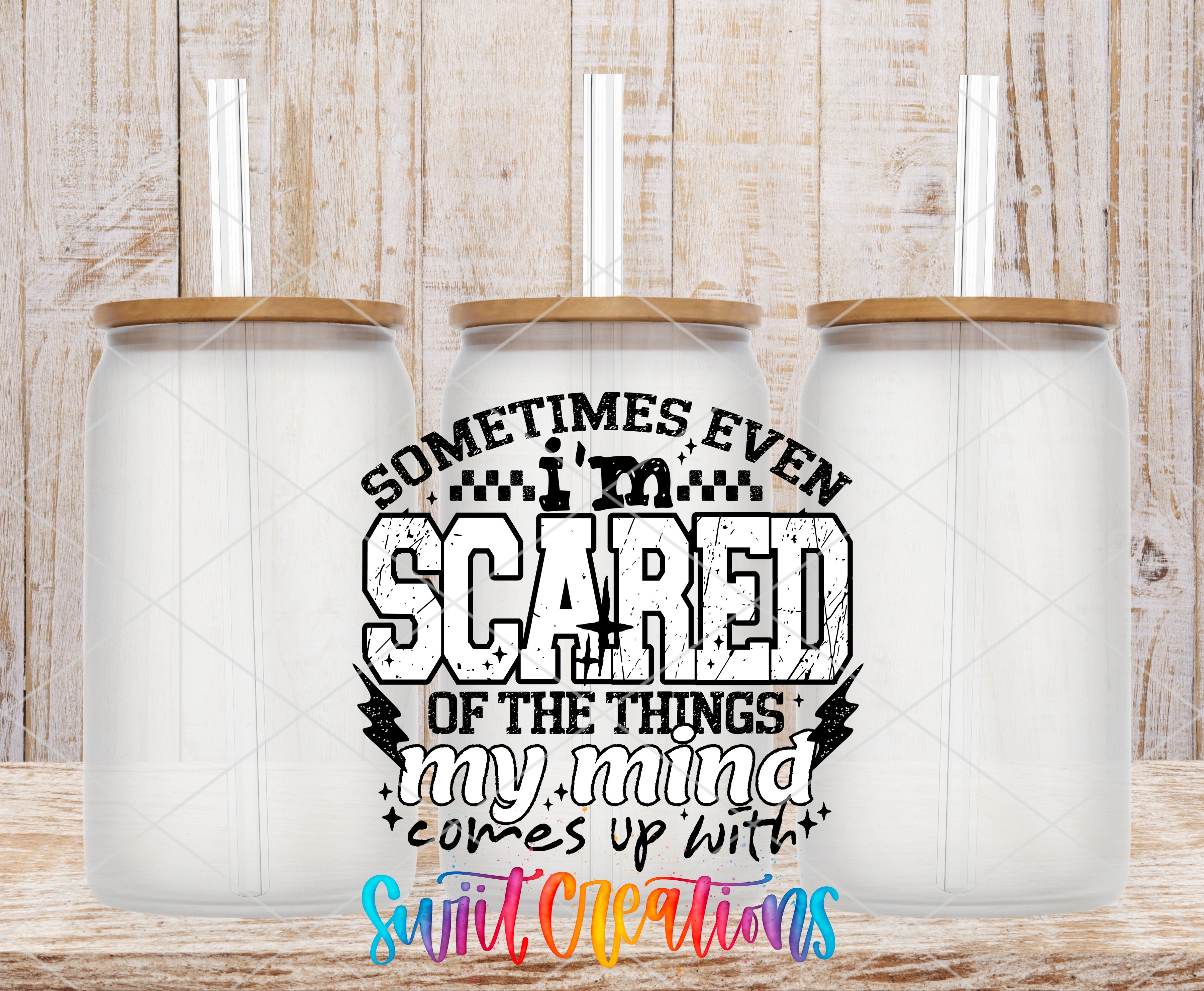 three clear glass jars with wooden lids, arranged in a row against a wooden background. In the center of the image, there is a text overlay that reads "Sometimes even I'm scared of the things my mind comes up with", accompanied by a graphic design element.