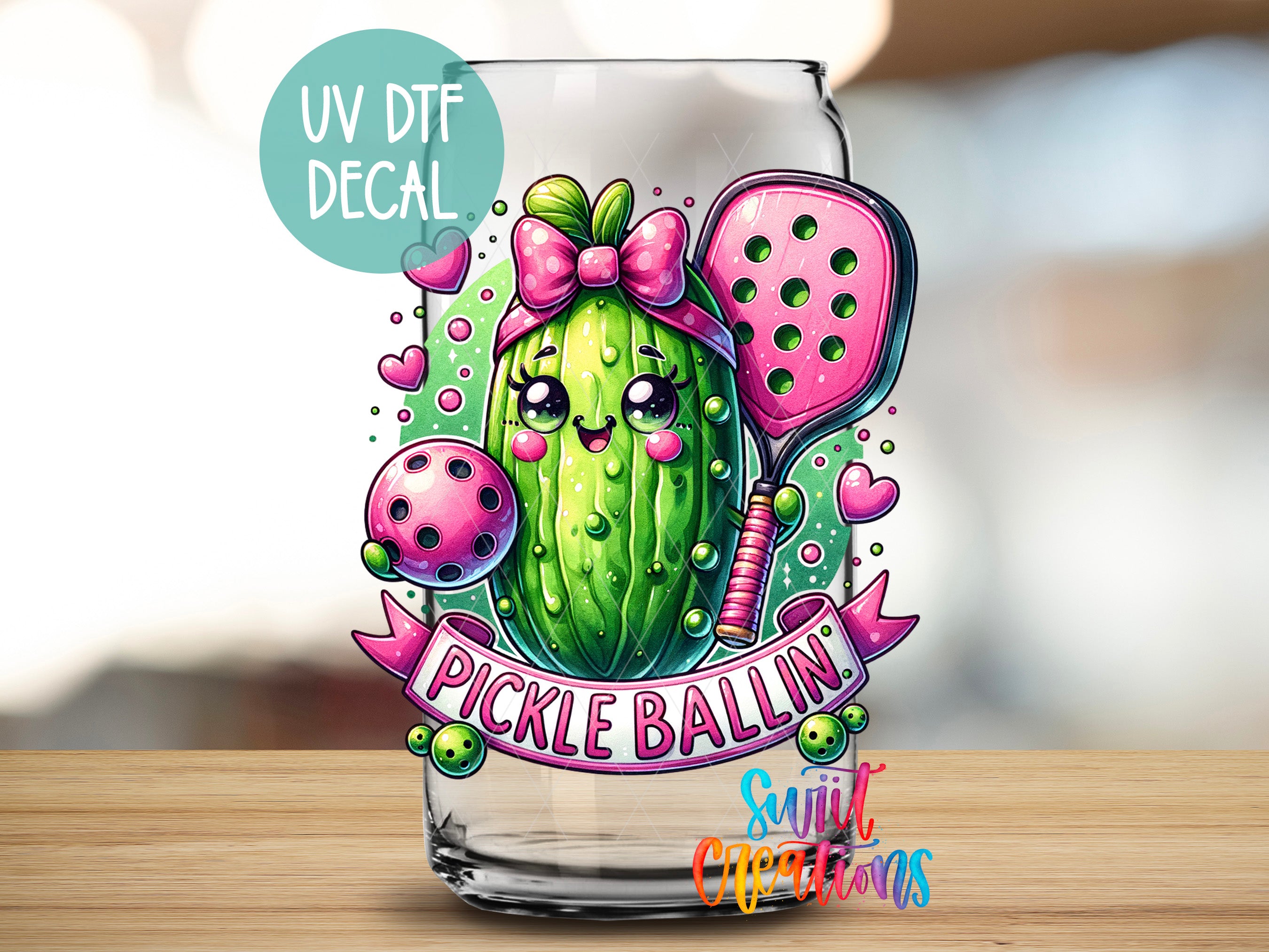 A glass jar with a cartoon illustration of a pickle wearing a pink bow and holding a tennis racket, surrounded by hearts and the text "Pickle Ballin".