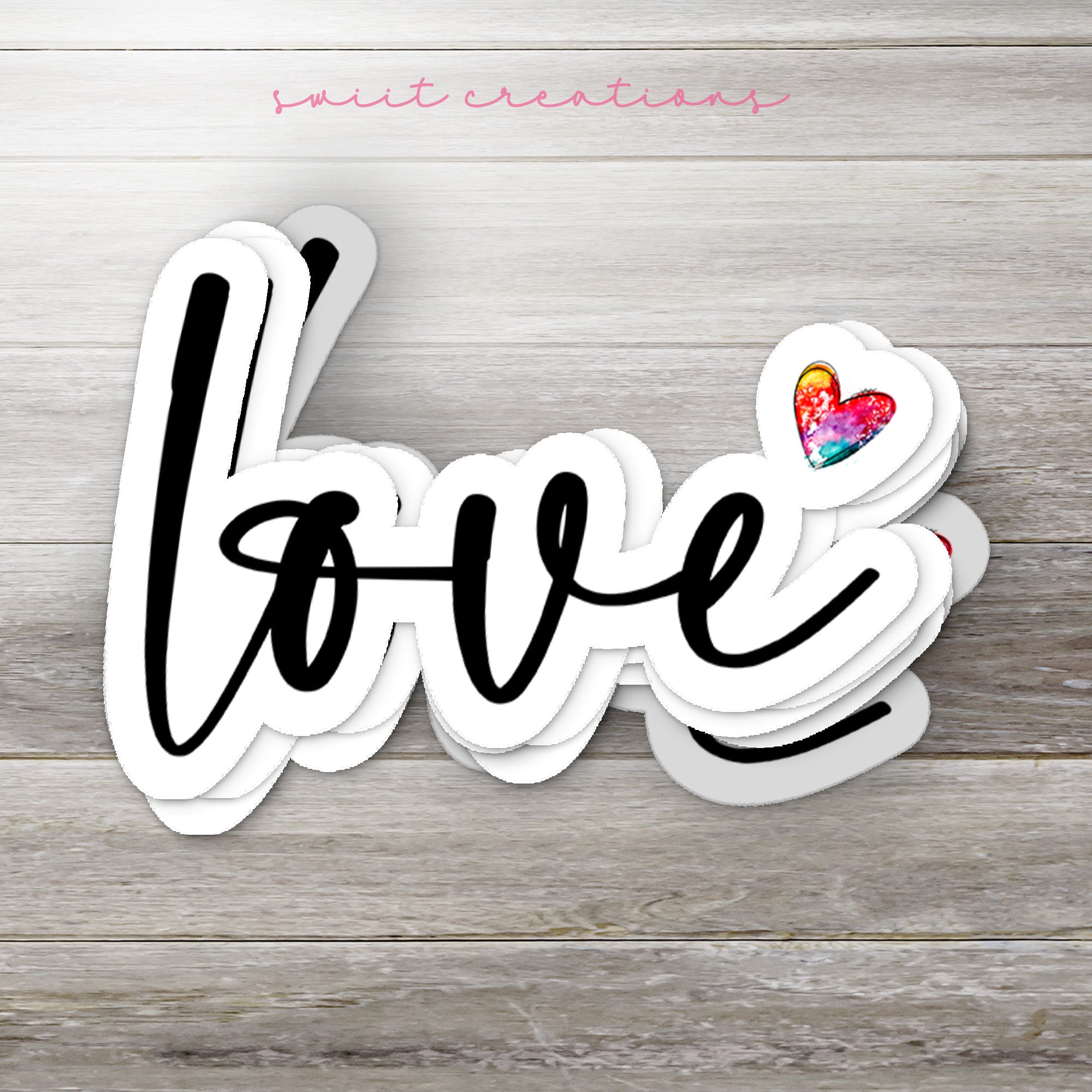 the word love written in black ink on a wooden background