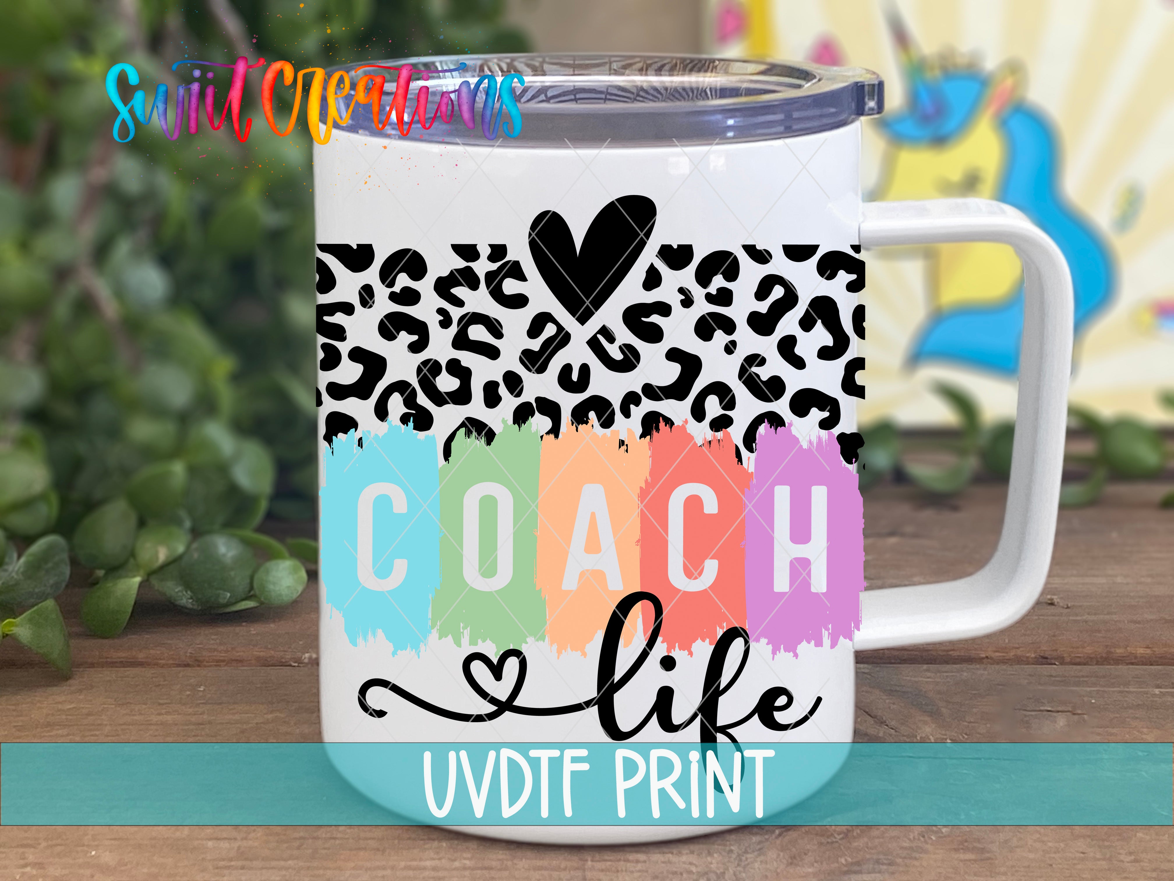 A white insulated mug with a leopard print design and the text "COACH life UVDF PRINT" printed on it.