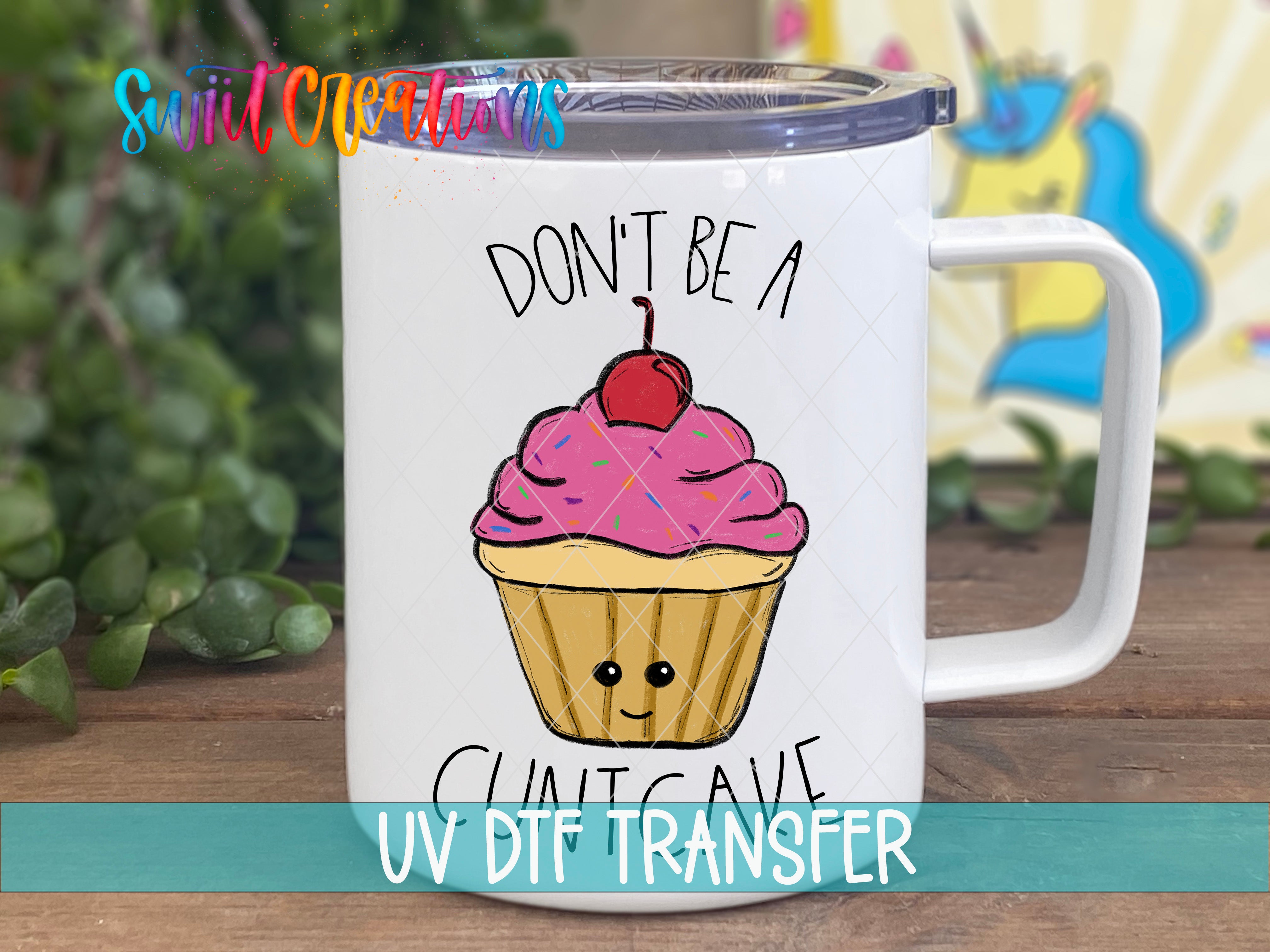 A white mug with a cupcake design and the text "DON'T BE A CUT CAVE UV Dtf Transfer" printed on it.
