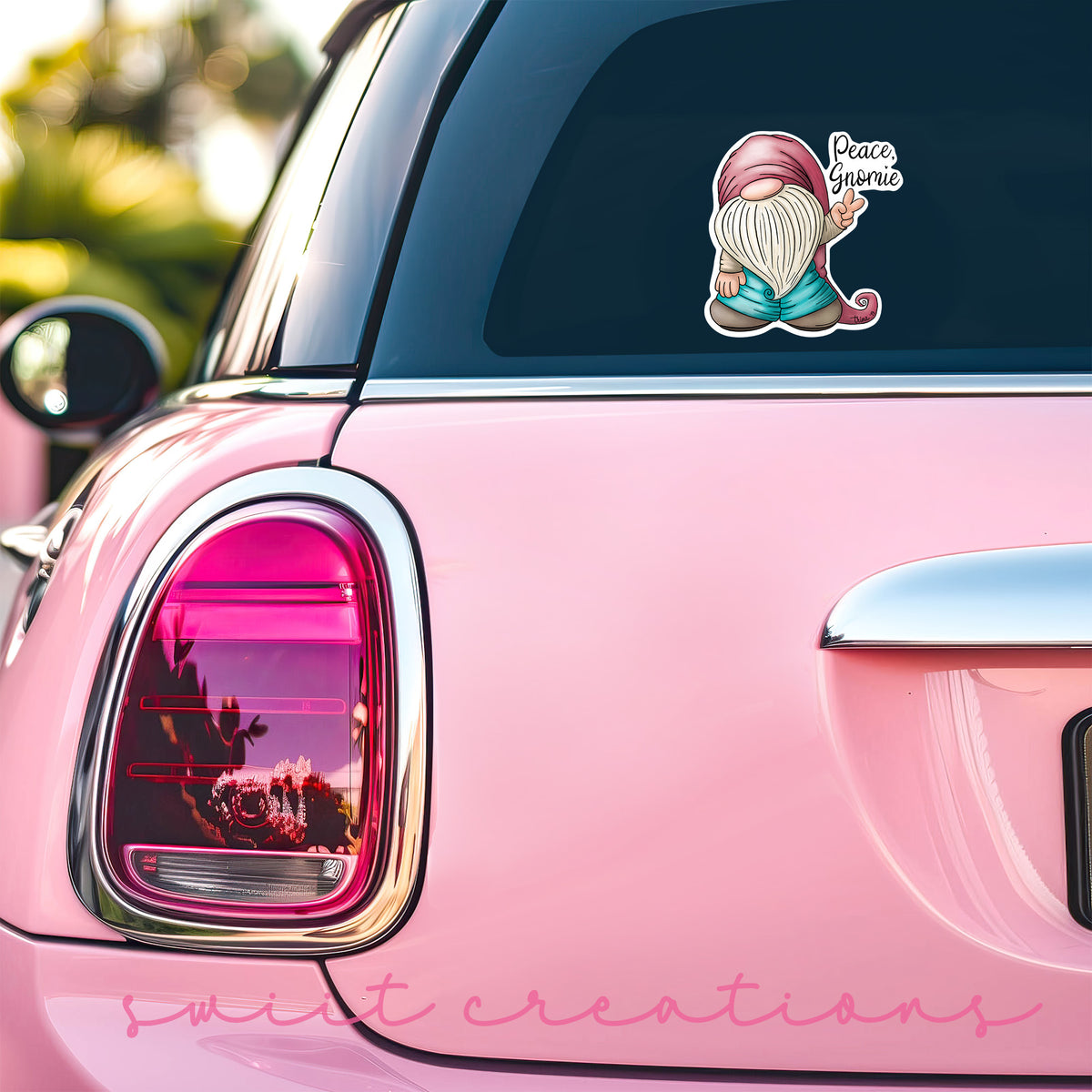 a pink car with a sticker of a mermaid