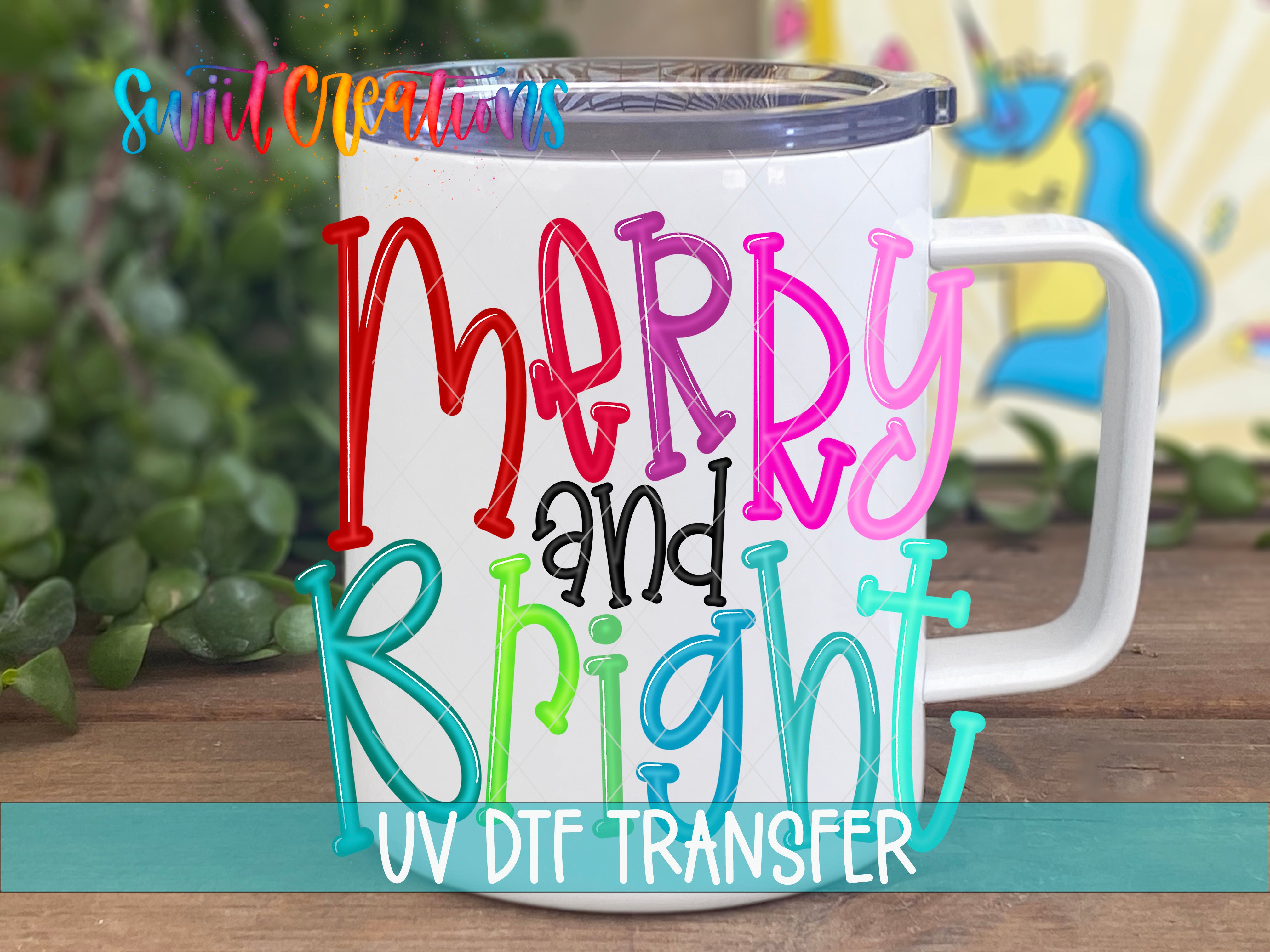 A white mug with colorful text that says "Merry and Bright" on it, placed on a wooden surface with some greenery in the background.