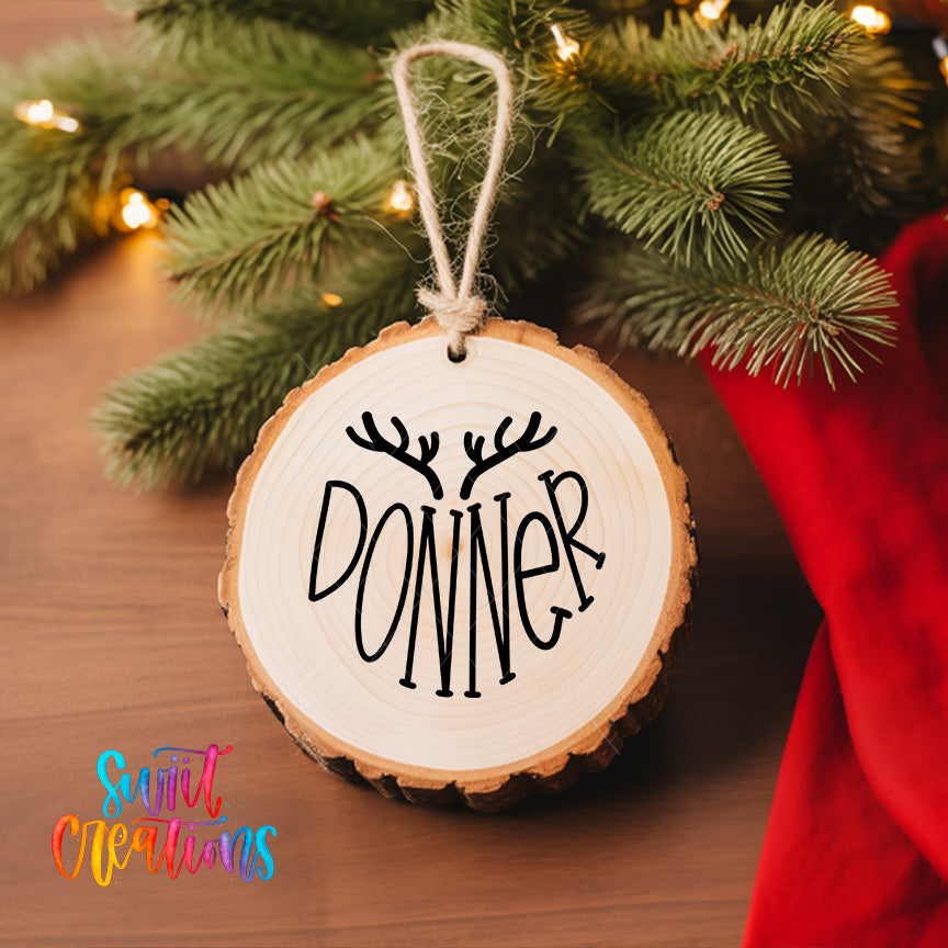 A wooden ornament with the name "DONNER" written on it, hanging on a Christmas tree.