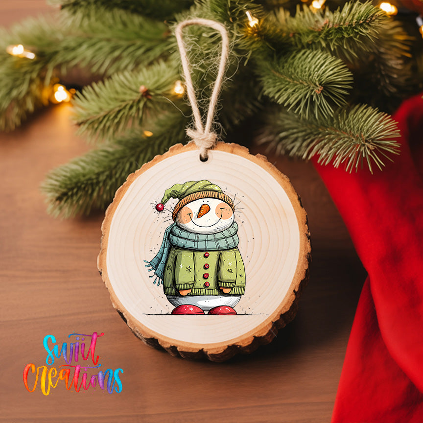A wooden ornament featuring a smiling snowman is hanging on a Christmas tree, surrounded by pine branches and twinkling lights.