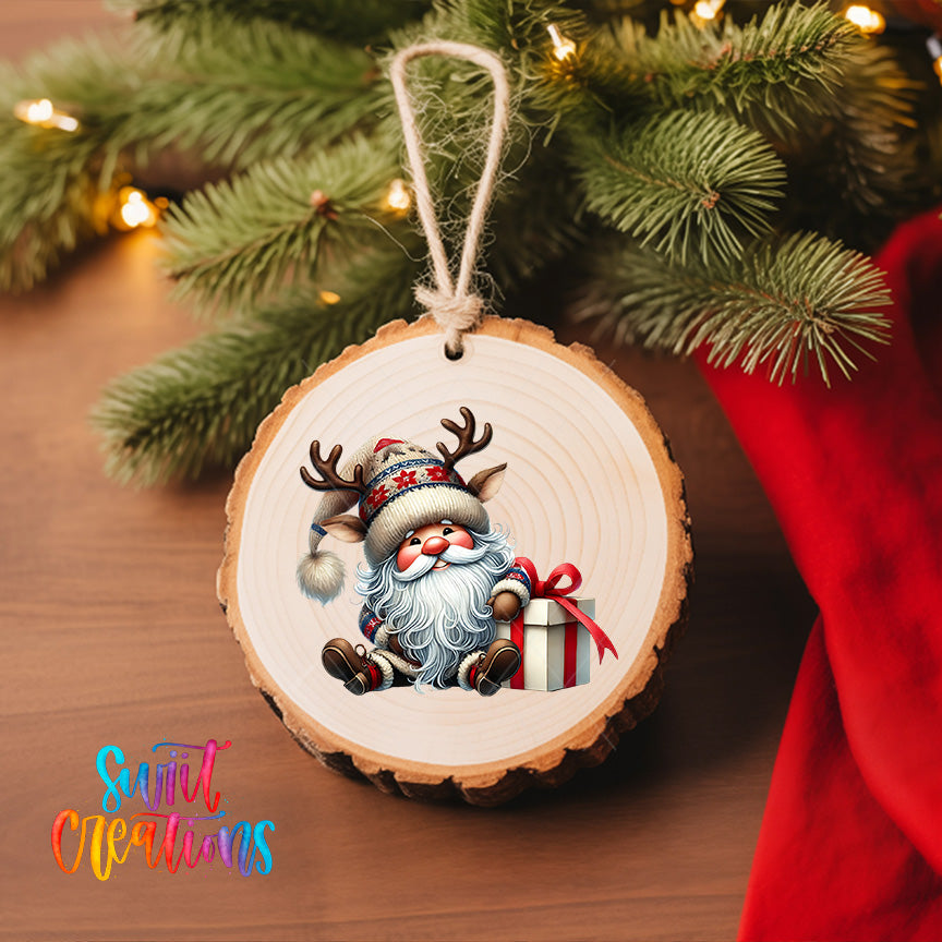 A wooden ornament featuring a smiling Santa Claus holding a gift box, hanging on a Christmas tree.