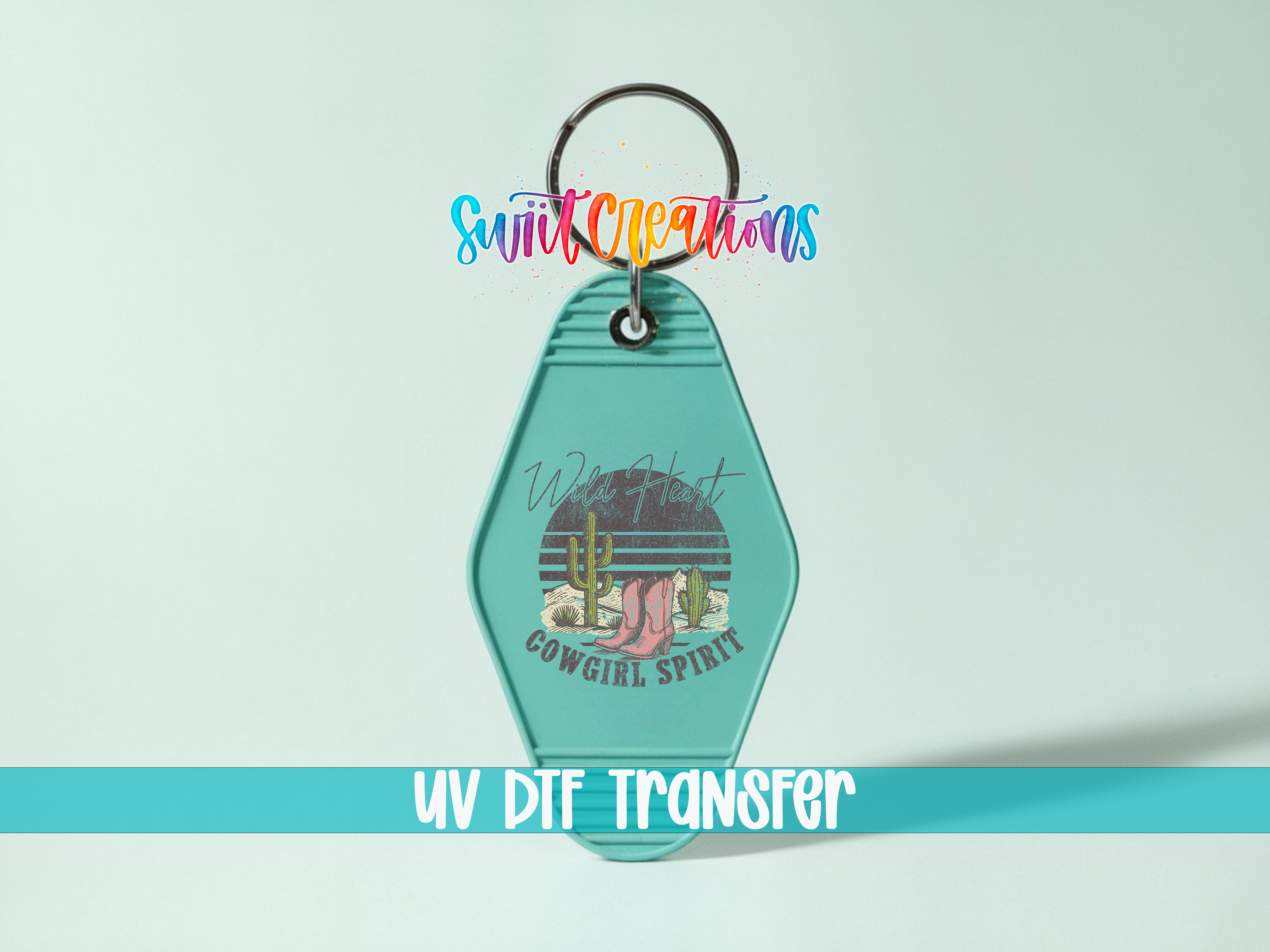A keychain with a graphic design featuring a cactus and the text "Wild Girl Cowboy Spirit".