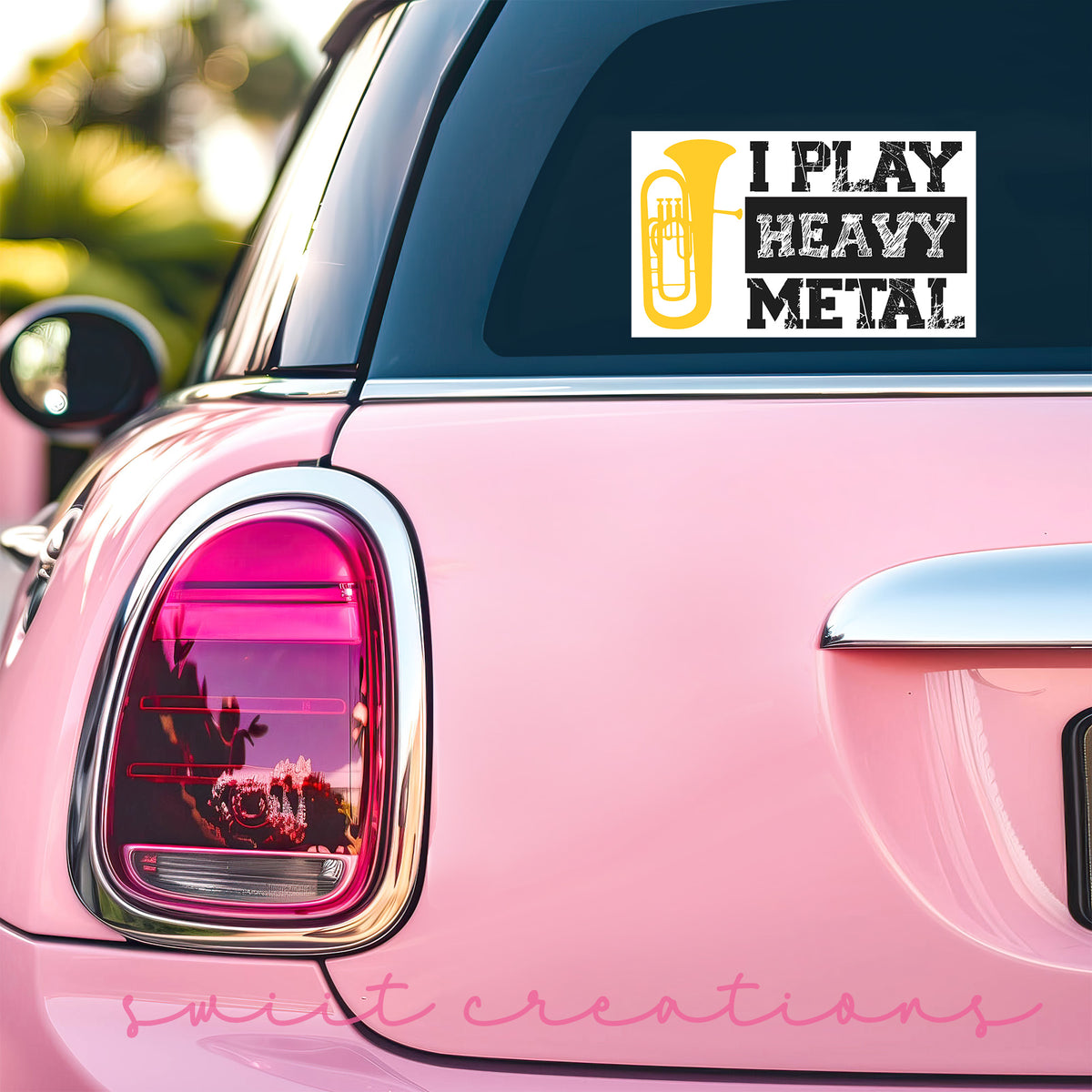 a pink car with a sticker that says i play heavy metal