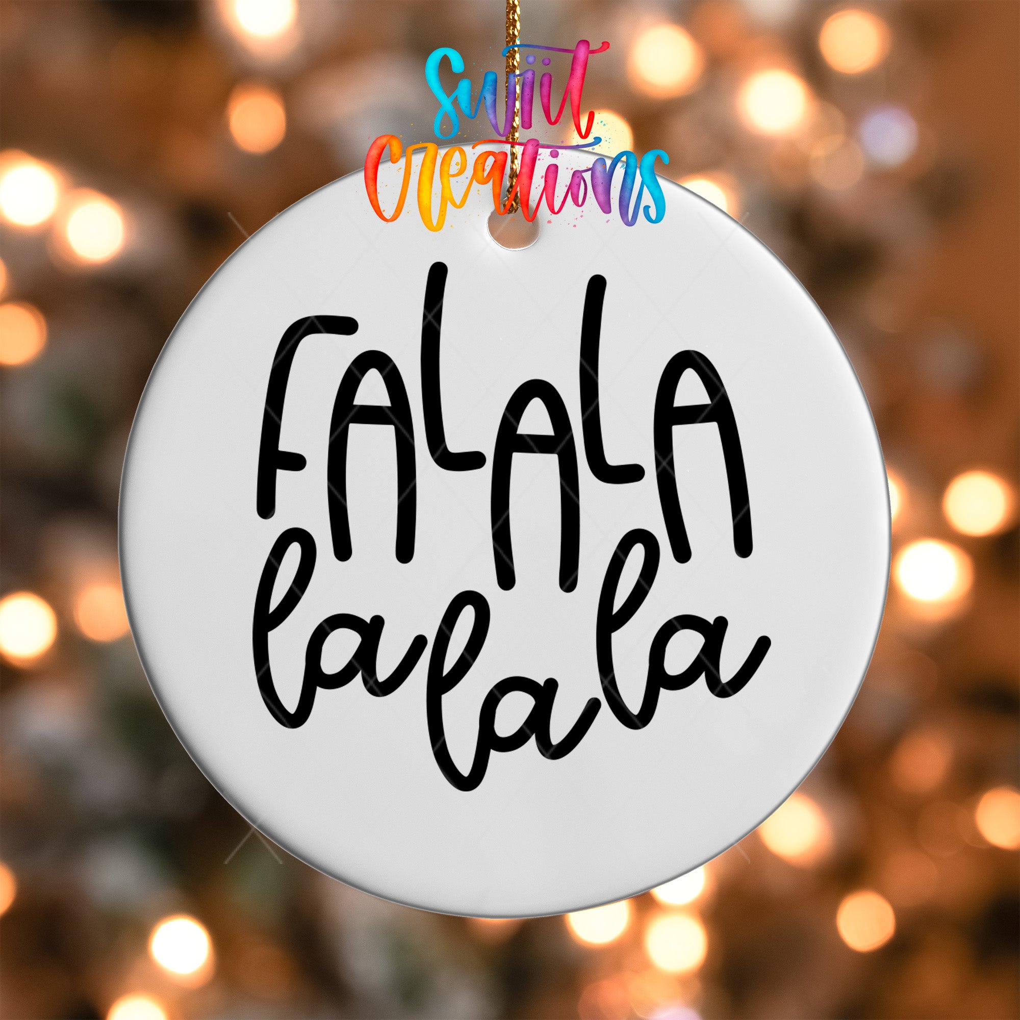 A white circular ornament with the text "FALA" written on it, hanging against a background of colorful lights.