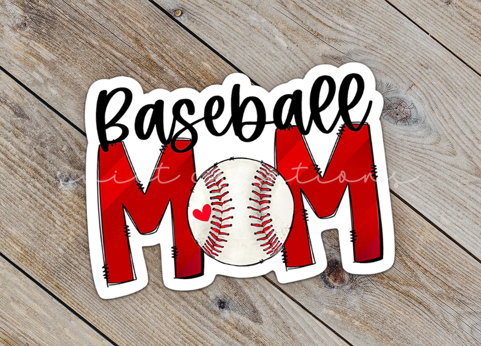 a baseball mom sticker sitting on top of a wooden table