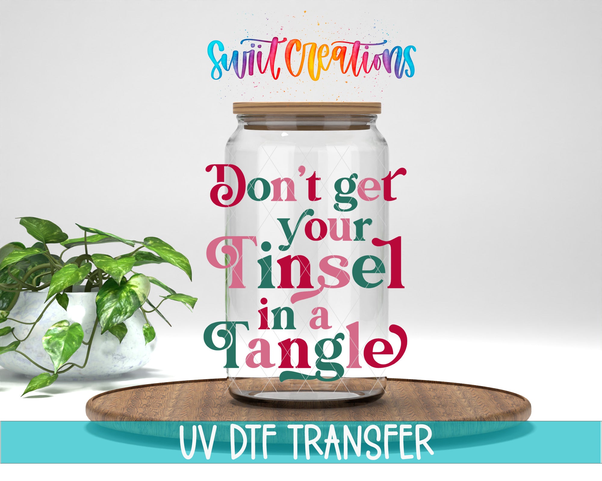 a glass jar with a wooden lid, placed on a wooden surface, with a potted plant in the background. The text overlay on the image reads "Don't get your Tinsel in a tangled".