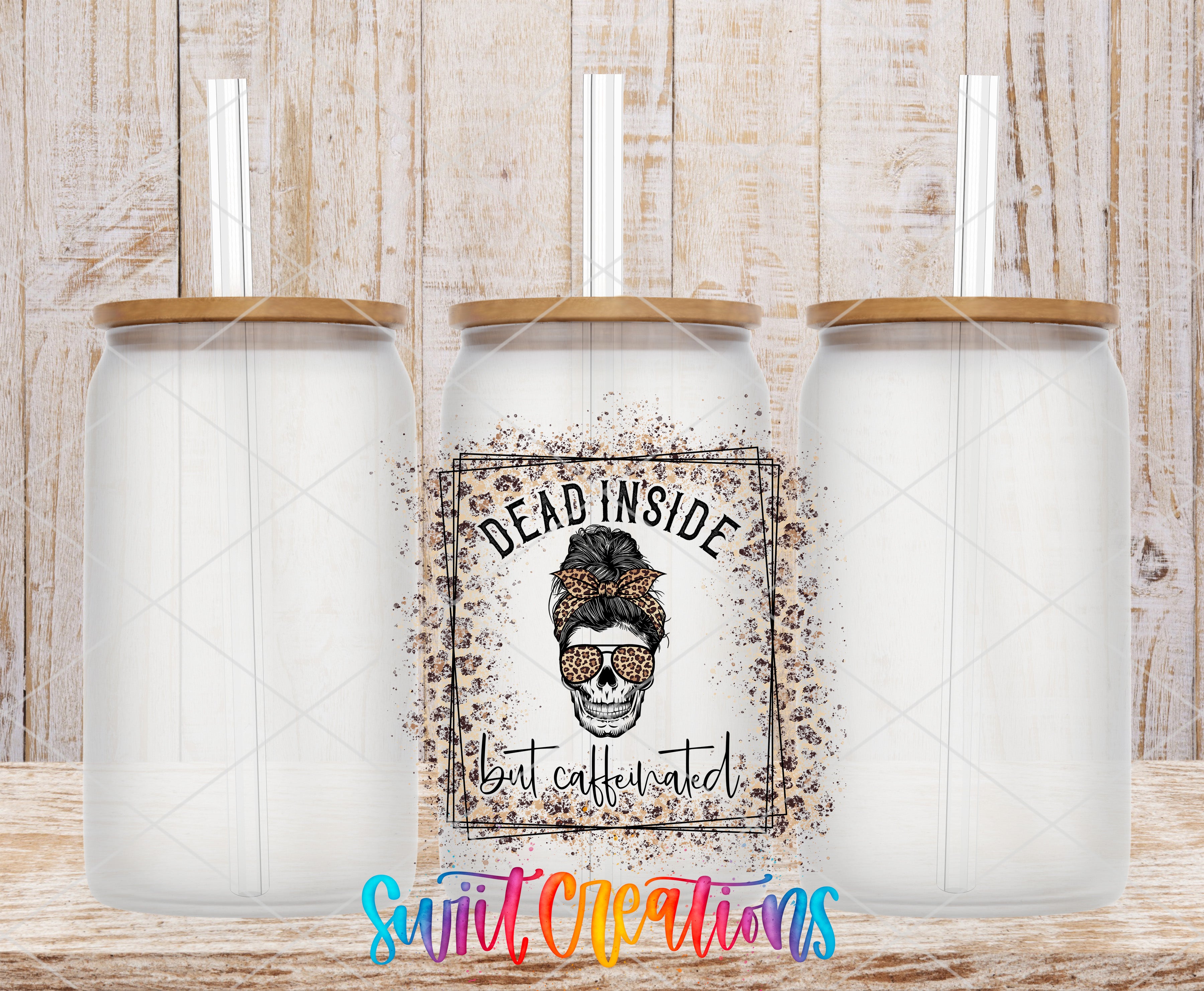 three clear glass jars with lids, each containing a straw. The jars are arranged in a row, with the middle jar having a label that reads "Dead Inside but caffeinated".