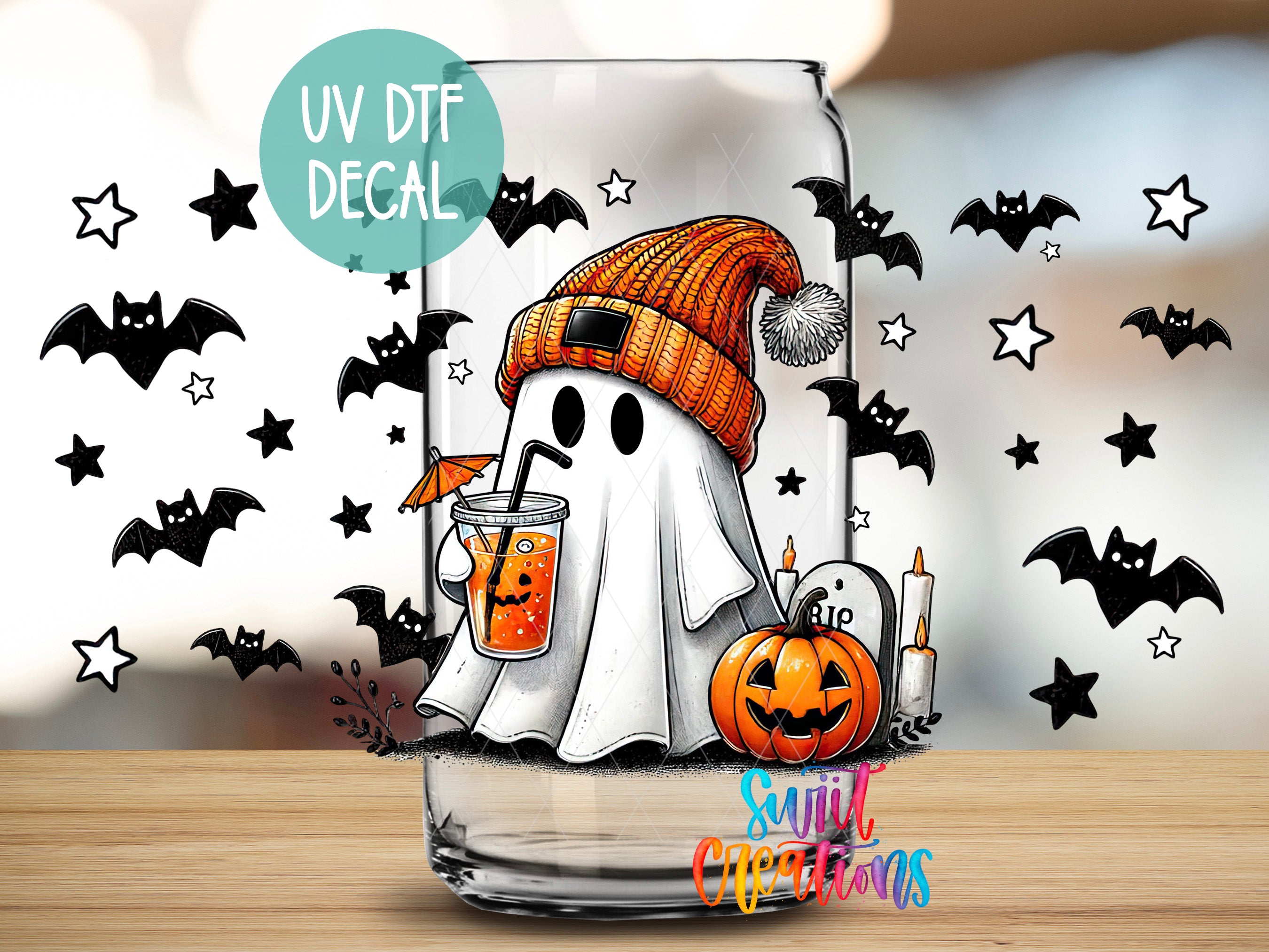 A Halloween-themed glass decal featuring a ghost wearing a knit hat and holding a drink, surrounded by bats and a pumpkin.