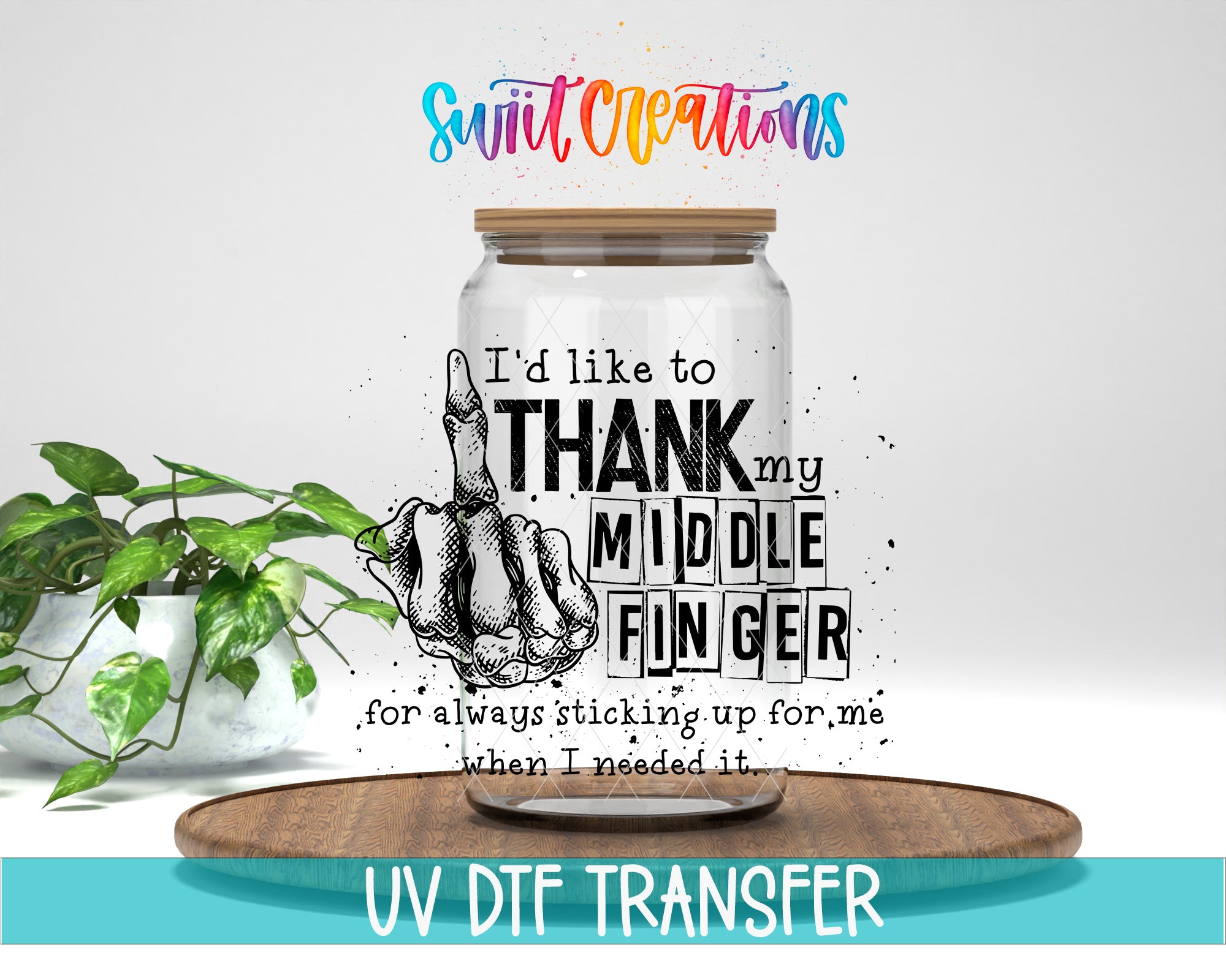 a jar with a hand sticking out of it, accompanied by text that reads "I'd like to THANK my MIDDLE FINGER for always sticking up for me when I needed it." The jar is placed on a wooden tray, and there is a potted plant in the background.