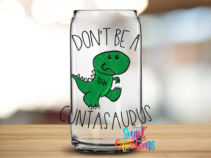 Glass can displaying the Swiit Creations Don’t Be a Cuntasaurus UV DTF transfer with a green cartoon dinosaur.