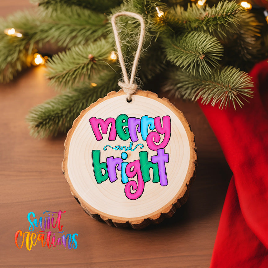 A wooden ornament with the text "mercy and bright" hanging from a tree branch, surrounded by pine needles and twinkling lights.