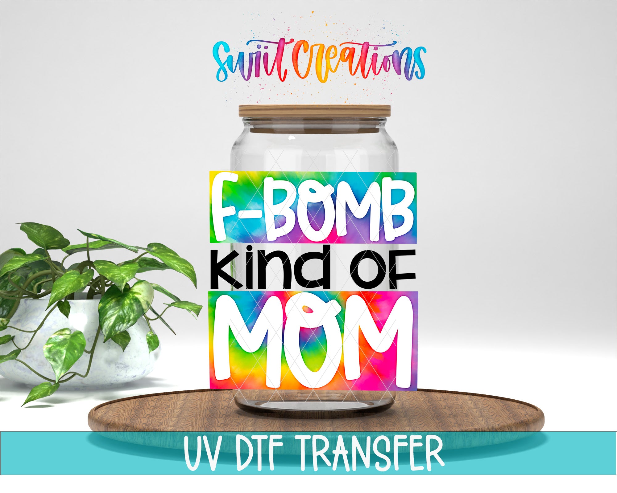 a glass jar with a colorful label that says "F-BOMB kind of MOM" and a wooden tray below it. There is also a plant in the background.