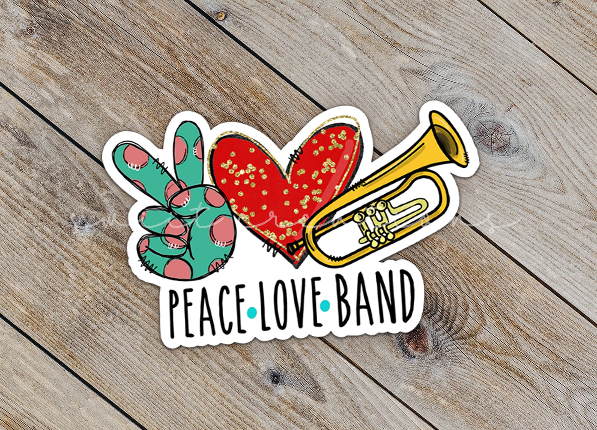 a peace love band sticker sitting on top of a wooden table