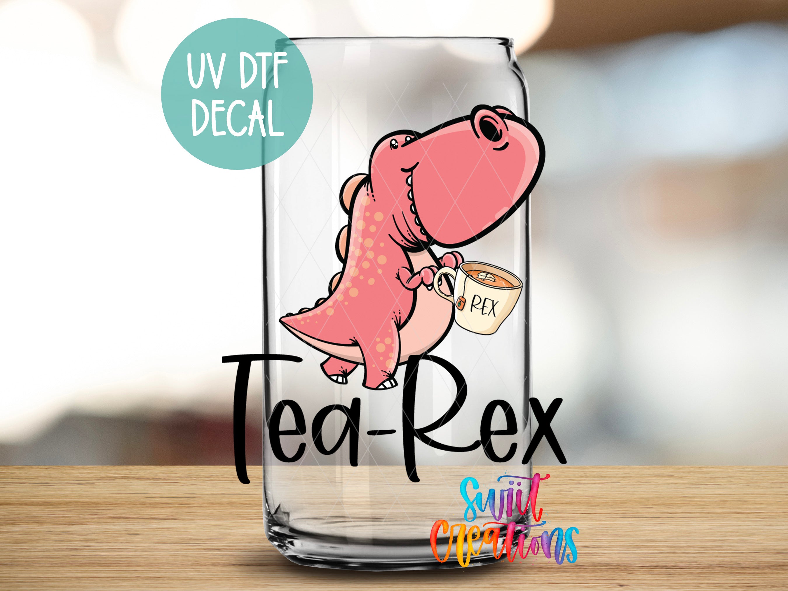 A glass can with a cartoon dinosaur holding a cup of tea, with the text "Tea-Rex" and "UV Dtf Decal" printed on it.