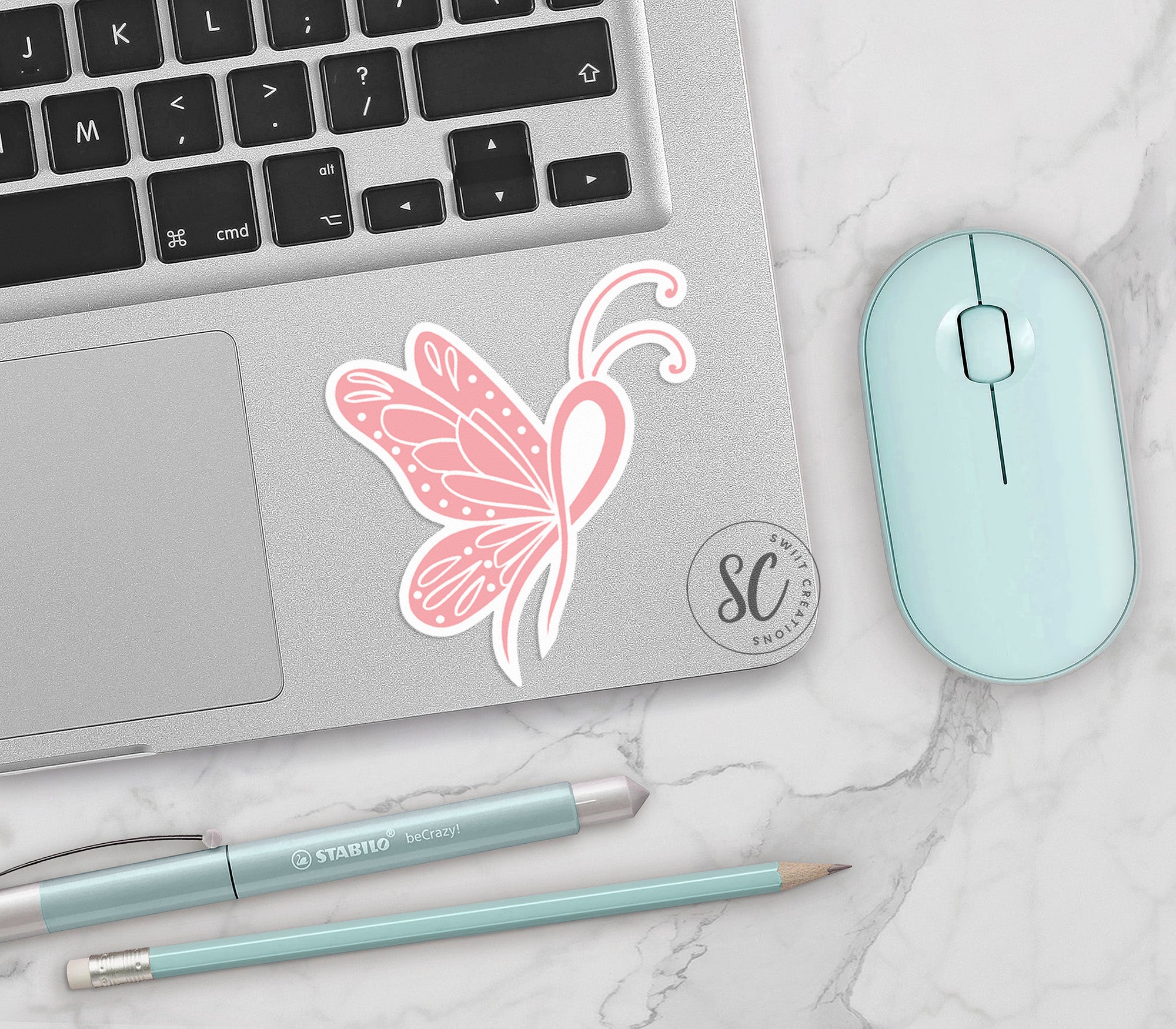 a laptop with a pink butterfly sticker on it