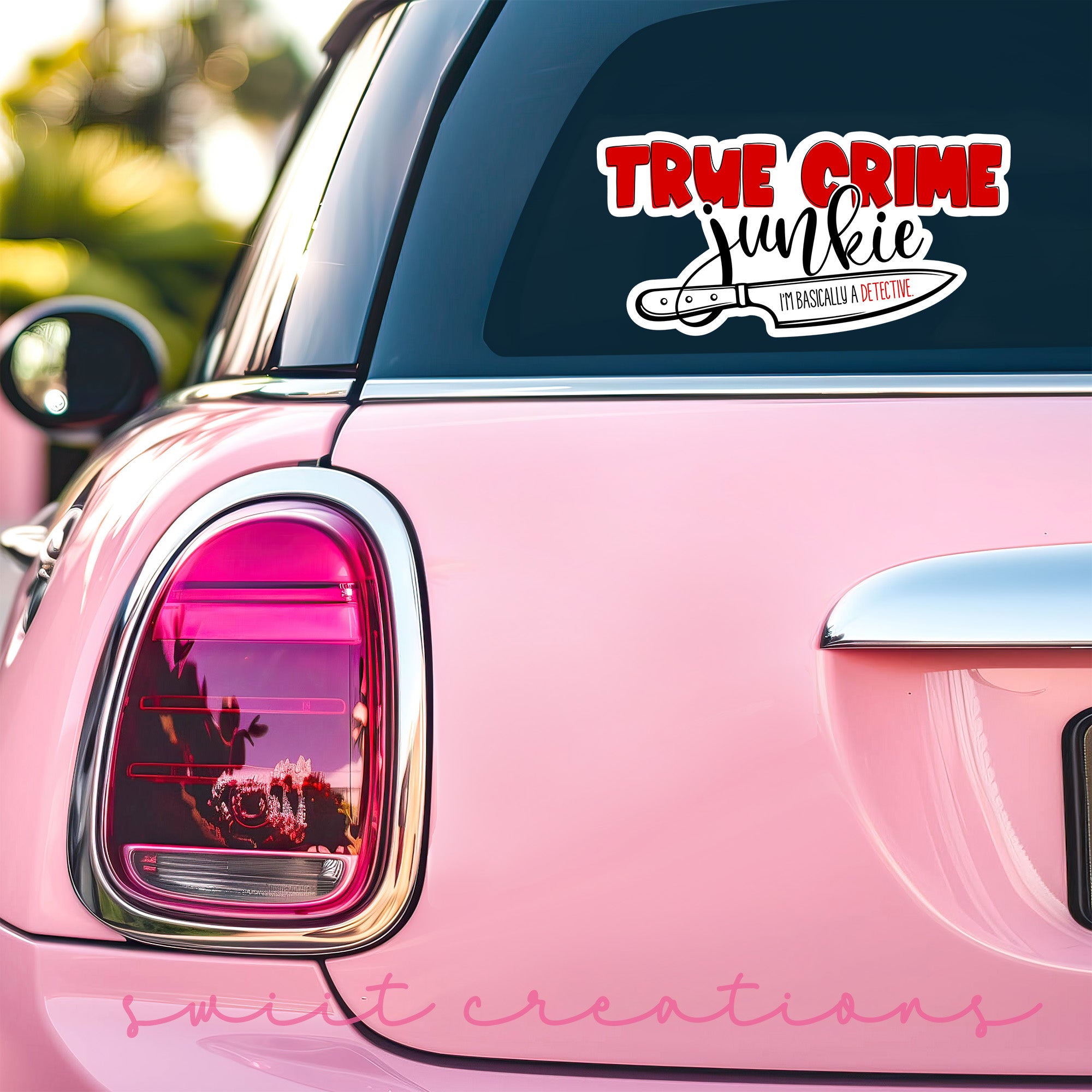a pink car that has a sticker on it