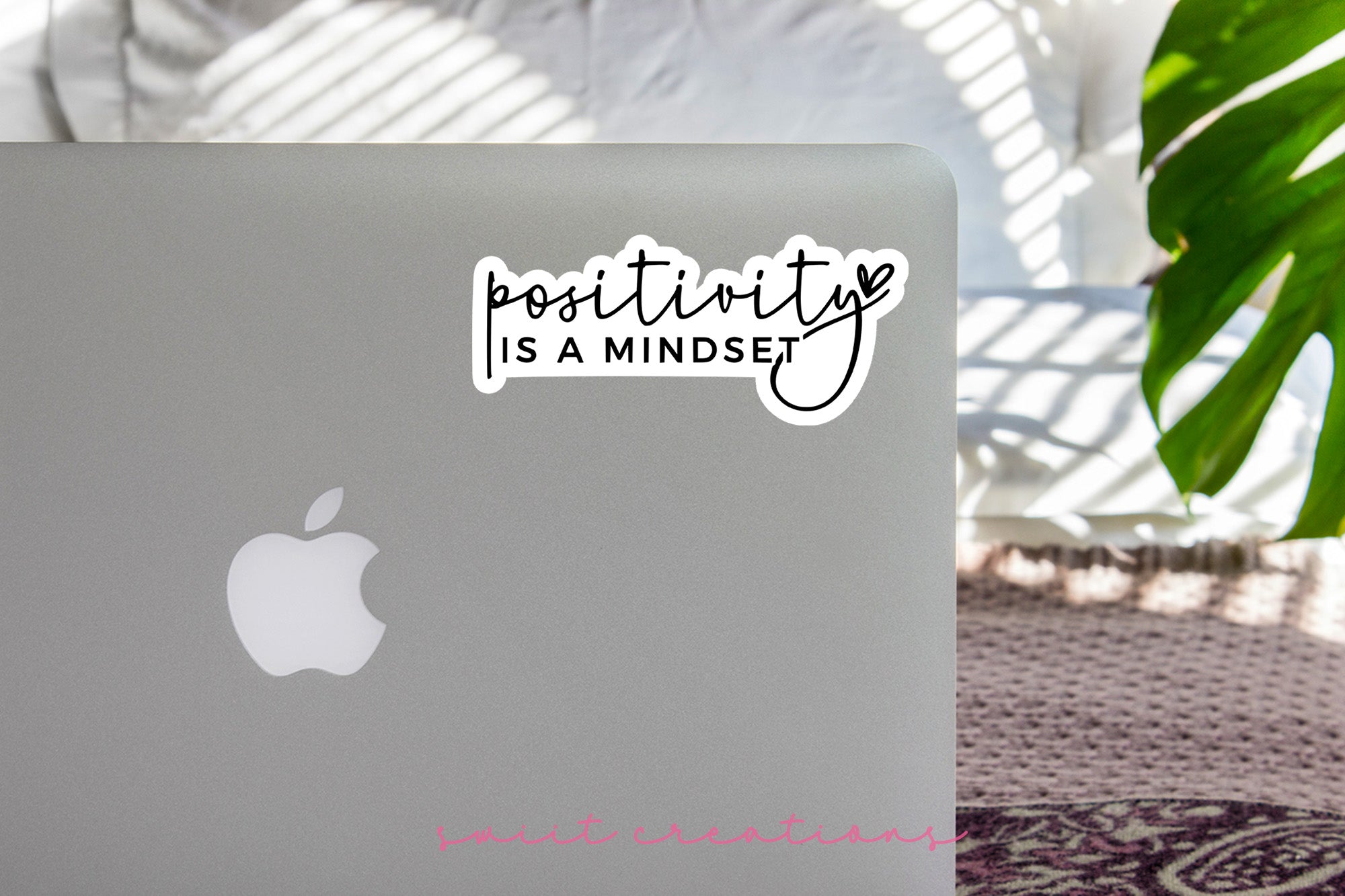 a laptop with a sticker that says positivity is a mindset