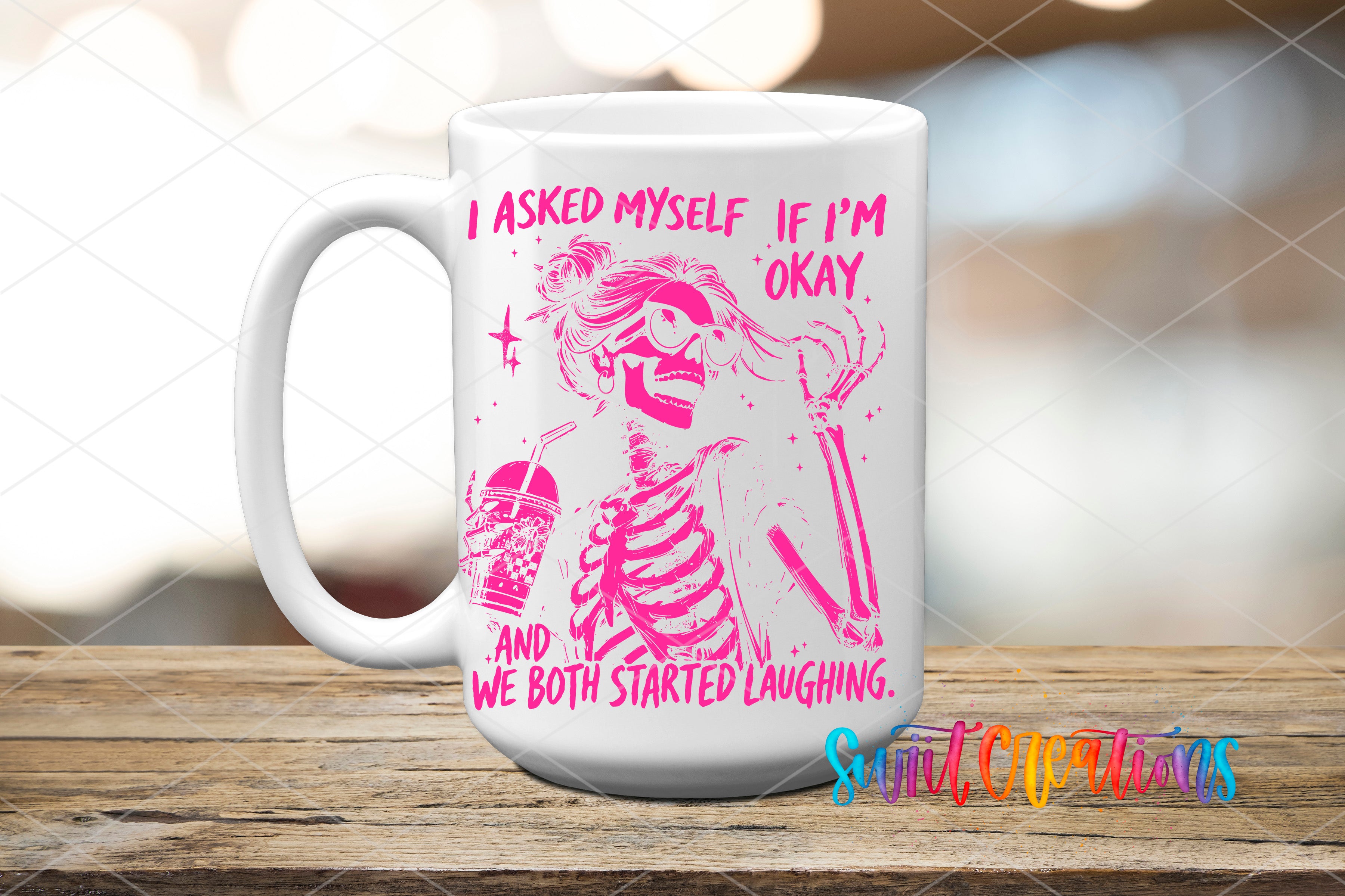 A white mug with a pink and purple design featuring a skeleton with a drink and text that reads "I asked myself if I'm okay. And we both started laughing."
