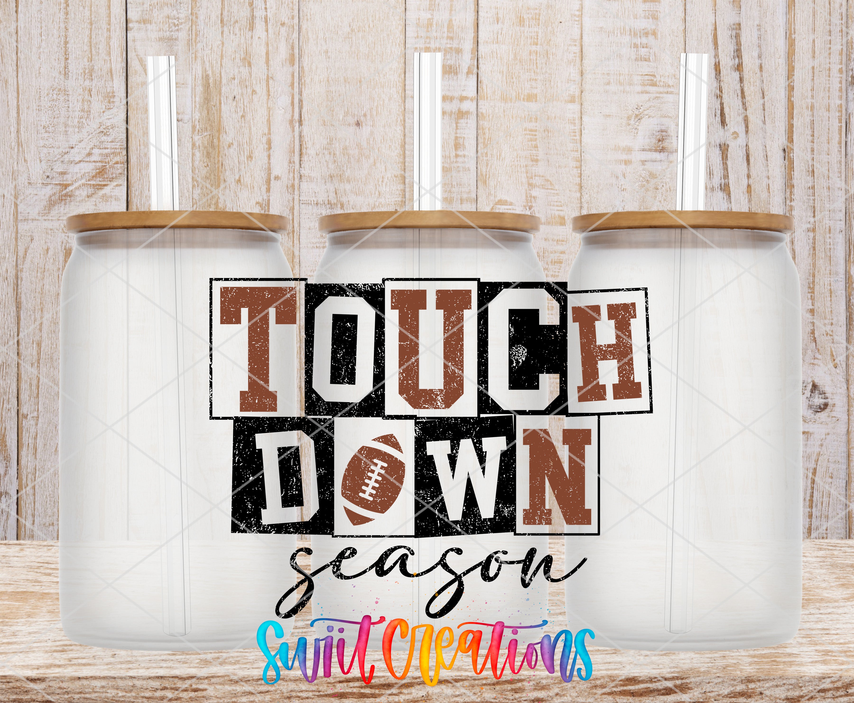 three white glass jars with brown lids, arranged in a row against a wooden background. The jars have straws sticking out of the lids. The text "TOUCH DOWN" is prominently displayed in the center of the image, with the word "season" written below it.